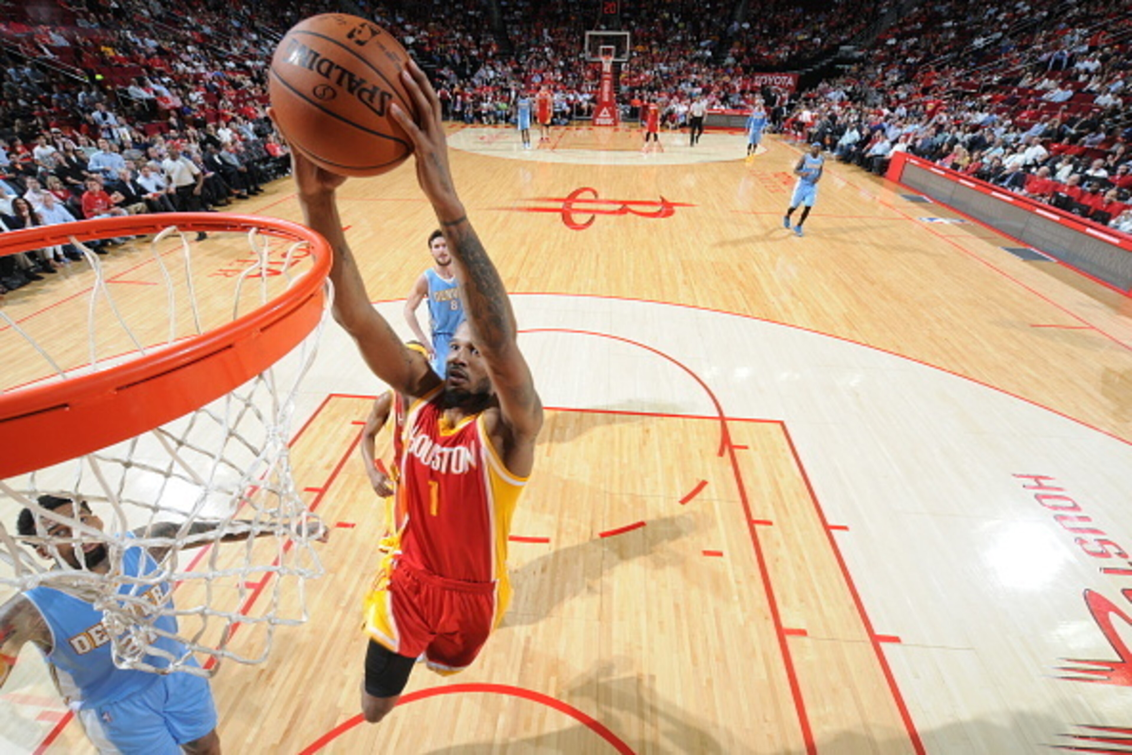 HOUSTON, TX - MARCH 19: Trevor Ariza #1 of the Houston Rockets dunks against the Denver Nuggets on March 19, 2015 at the Toyota Center in Houston, Texas. NOTE TO USER: User expressly acknowledges and agrees that, by downloading and or using this photograp