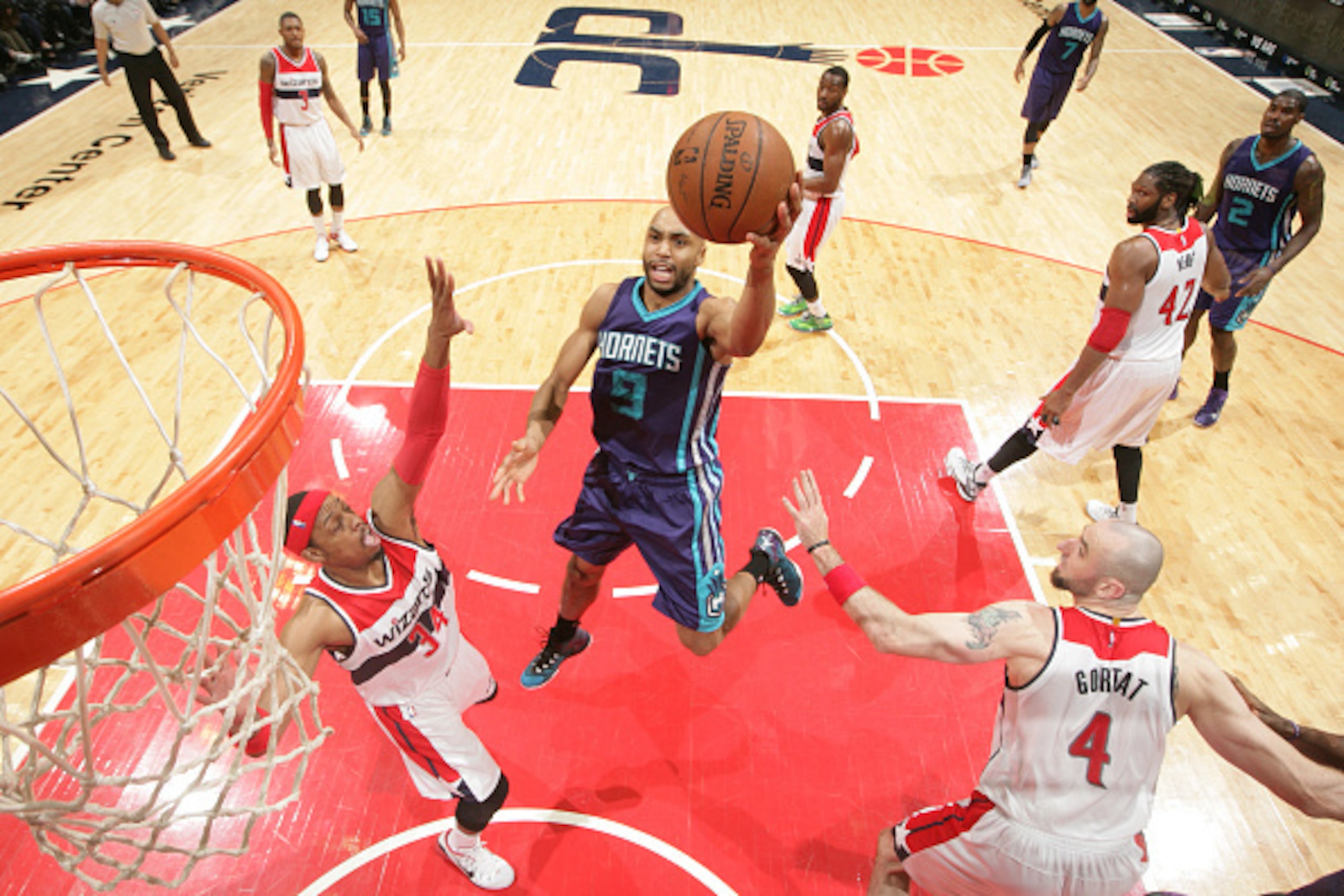 WASHINGTON, DC - MARCH 27: Gerald Henderson #9 of the Charlotte Hornets shoots against Marcin Gortat #4 and Paul Pierce #34 of the Washington Wizards during a game at the Verizon Center on March 27, 2015 in Washington, DC. NOTE TO USER: User expressly ack