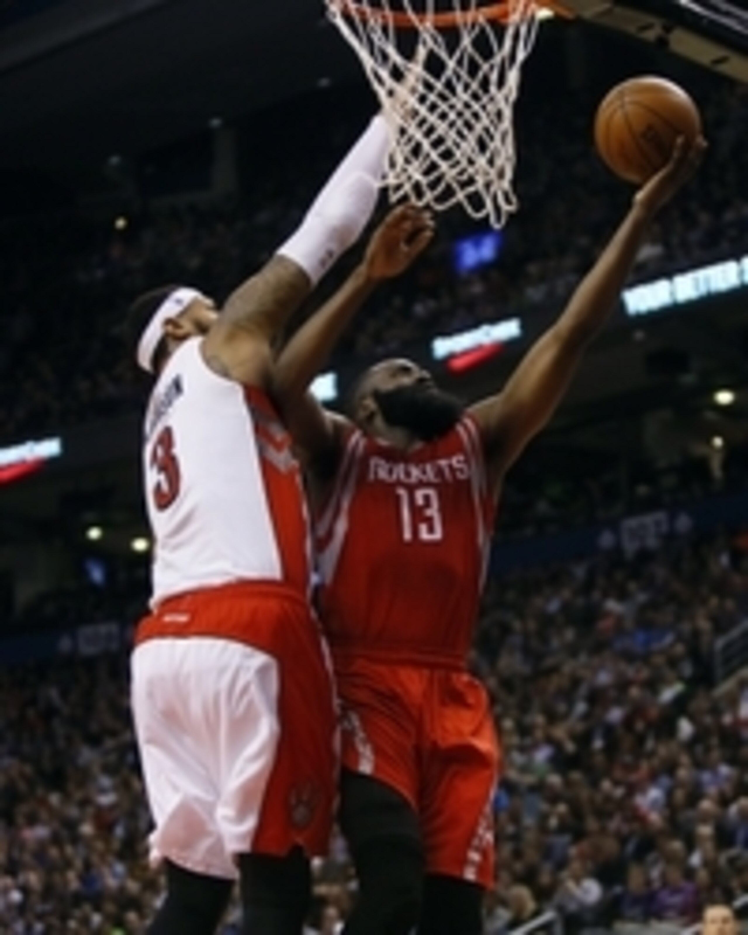 Mar 30, 2015; Toronto, Ontario, CAN; Houston Rockets guard James Harden (13) goes up to make a basket as Toronto Raptors forward James Johnson (3) defends at the Air Canada Centre. Toronto defeated Houston 99-96. Mandatory Credit: John E. Sokolowski-USA T