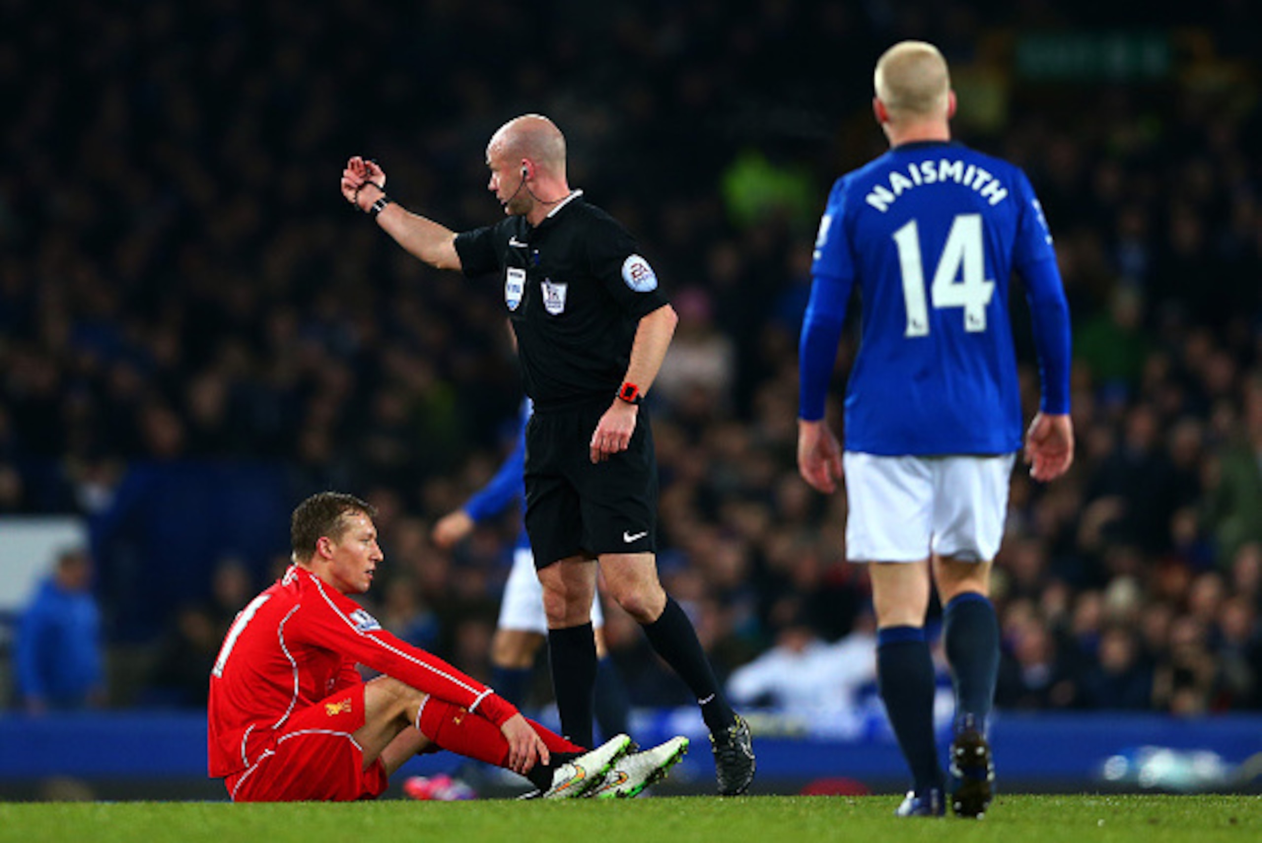 LIVERPOOL, ENGLAND - FEBRUARY 07: Referee Anthony Taylor signals to the bench as Lucas Leiva of Liverpool sits on the turf injured during the Barclays Premier League match between Everton and Liverpool at Goodison Park on February 7, 2015 in Liverpool, E LIVERPOOL, ENGLAND - FEBRUARY 07: Referee Anthony Taylor signals to the bench as Lucas Leiva of Liverpool sits on the turf injured during the Barclays Premier League match between Everton and Liverpool at Goodison Park on February 7, 2015 in Liverpool, E