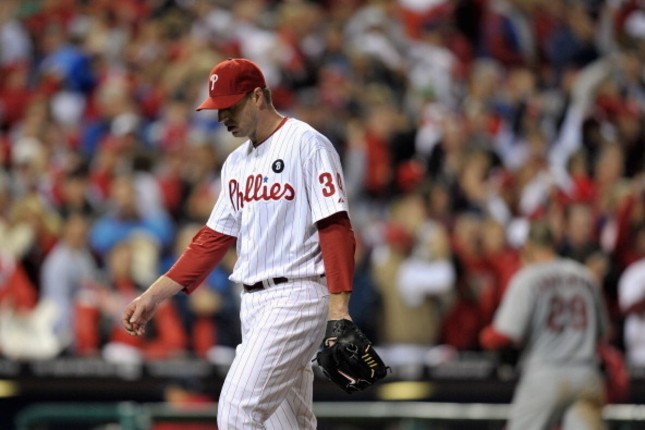 PHILADELPHIA, PA - OCTOBER 07:  (L-R) Starting pitchers Roy Halladay #34 of the Philadelphia Phillies and Chris Carpenter #29 of the St. Louis Cardinals both walk back to their dugouts during Game Five of the National League Divisional Series at Citizens