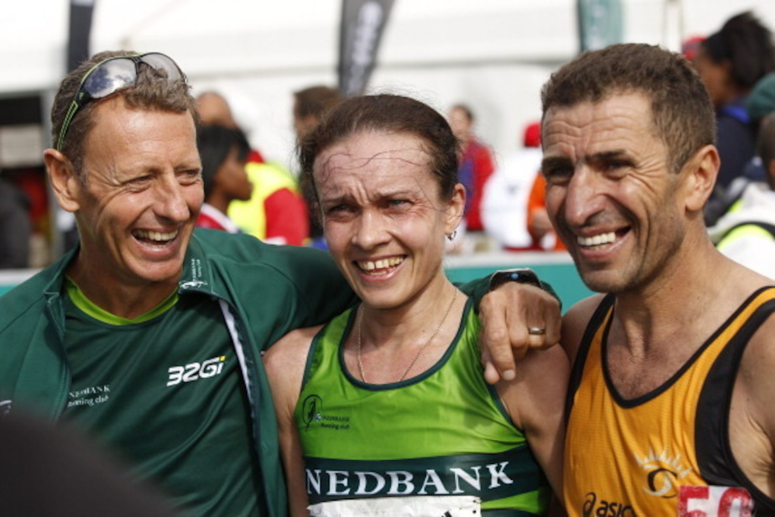 CAPE TOWN, SOUTH AFRICA - MARCH 30:  Natalia Volgina, race winner, with Nick Bester (L) and Vladimir Kotov (R) during the Old Mutual Two Oceans Ultra Marathon on March 30, 2013 in Cape Town, South Africa.  (Photo by Gallo Images/Getty Images)