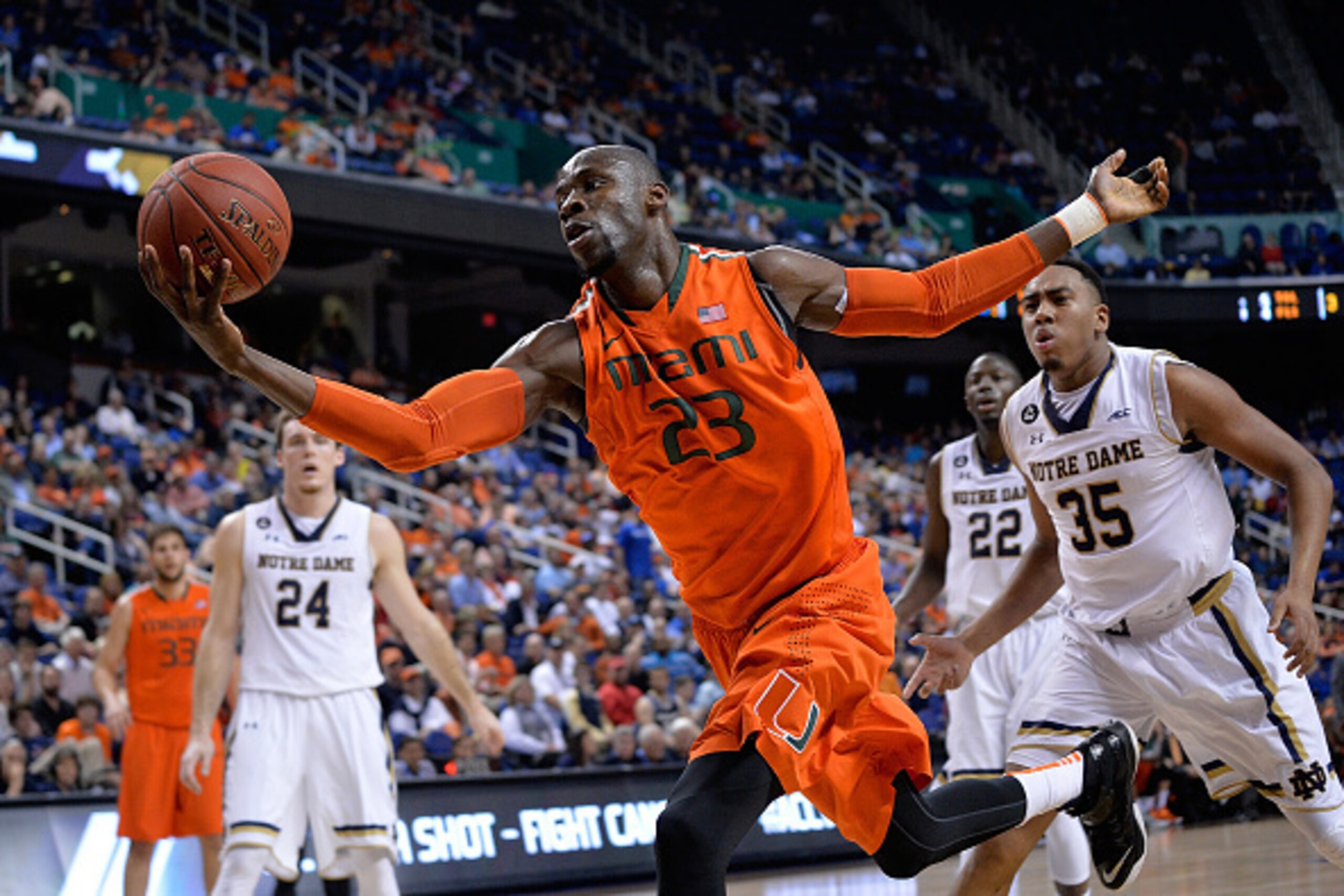 GREENSBORO, NC - MARCH 12:  Tonye Jekiri #23 of the Miami Hurricanes tracks down a loose ball on the end line against the Notre Dame Fighting Irish during the quarterfinals of the ACC Basketball Tournament at Greensboro Coliseum on March 12, 2015 in Green