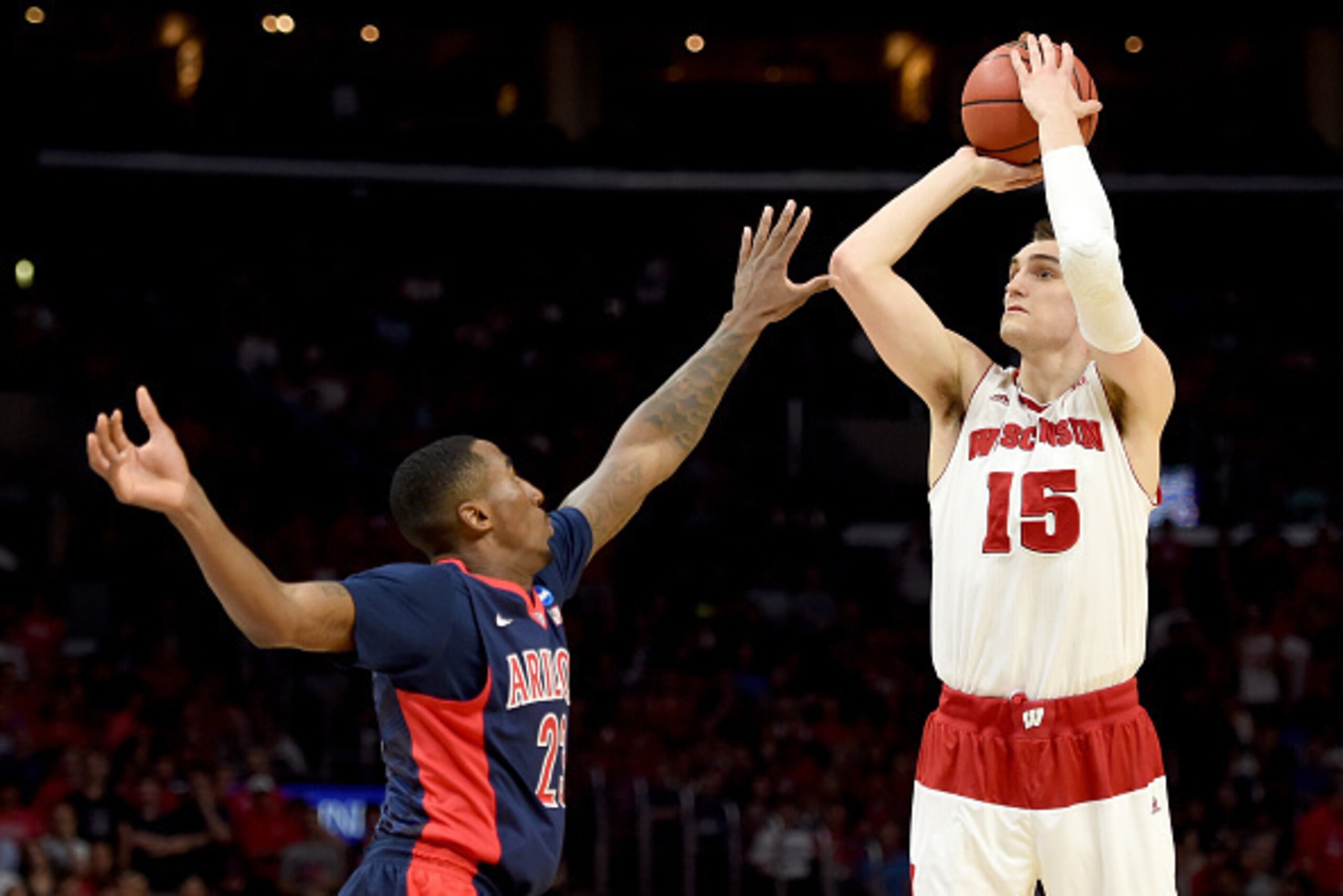 LOS ANGELES, CA - MARCH 28:  Sam Dekker #15 of the Wisconsin Badgers shoots a three-pointer over Rondae Hollis-Jefferson #23 of the Arizona Wildcats in the second half during the West Regional Final of the 2015 NCAA Men's Basketball Tournament at Staples 