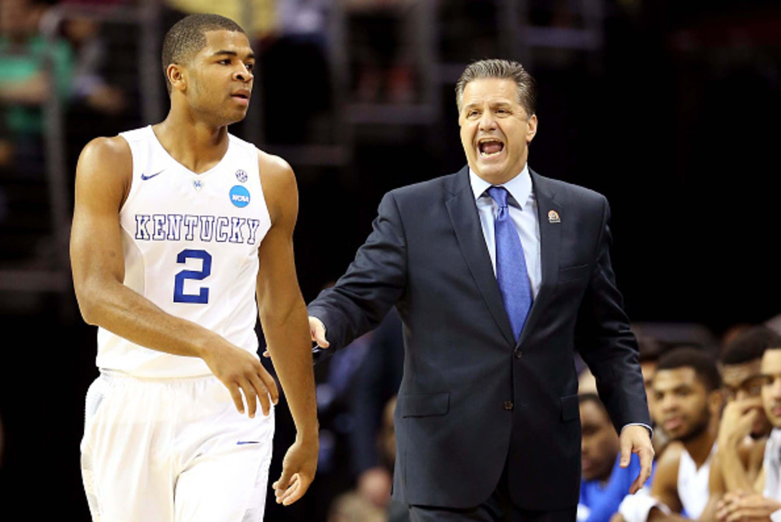 CLEVELAND, OH - MARCH 26: Head coach John Calipari of the Kentucky Wildcats reacts on the sideline with Aaron Harrison #2 in the first half against the West Virginia Mountaineers during the Midwest Regional semifinal of the 2015 NCAA Men's Basketball Tou CLEVELAND, OH - MARCH 26: Head coach John Calipari of the Kentucky Wildcats reacts on the sideline with Aaron Harrison #2 in the first half against the West Virginia Mountaineers during the Midwest Regional semifinal of the 2015 NCAA Men's Basketball Tou