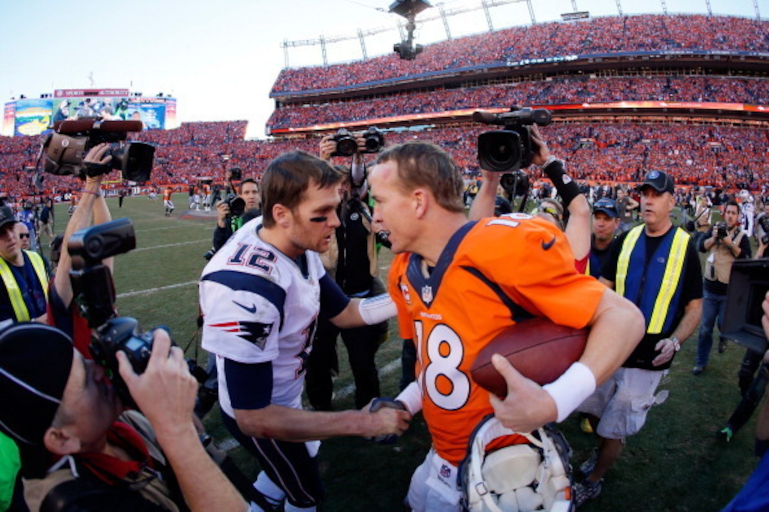 DENVER, CO - JANUARY 19:  Tom Brady #12 of the New England Patriots congratulates  Peyton Manning #18 of the Denver Broncos after the Broncos defeated the Patriots 26 to 16 during the AFC Championship game at Sports Authority Field at Mile High on January