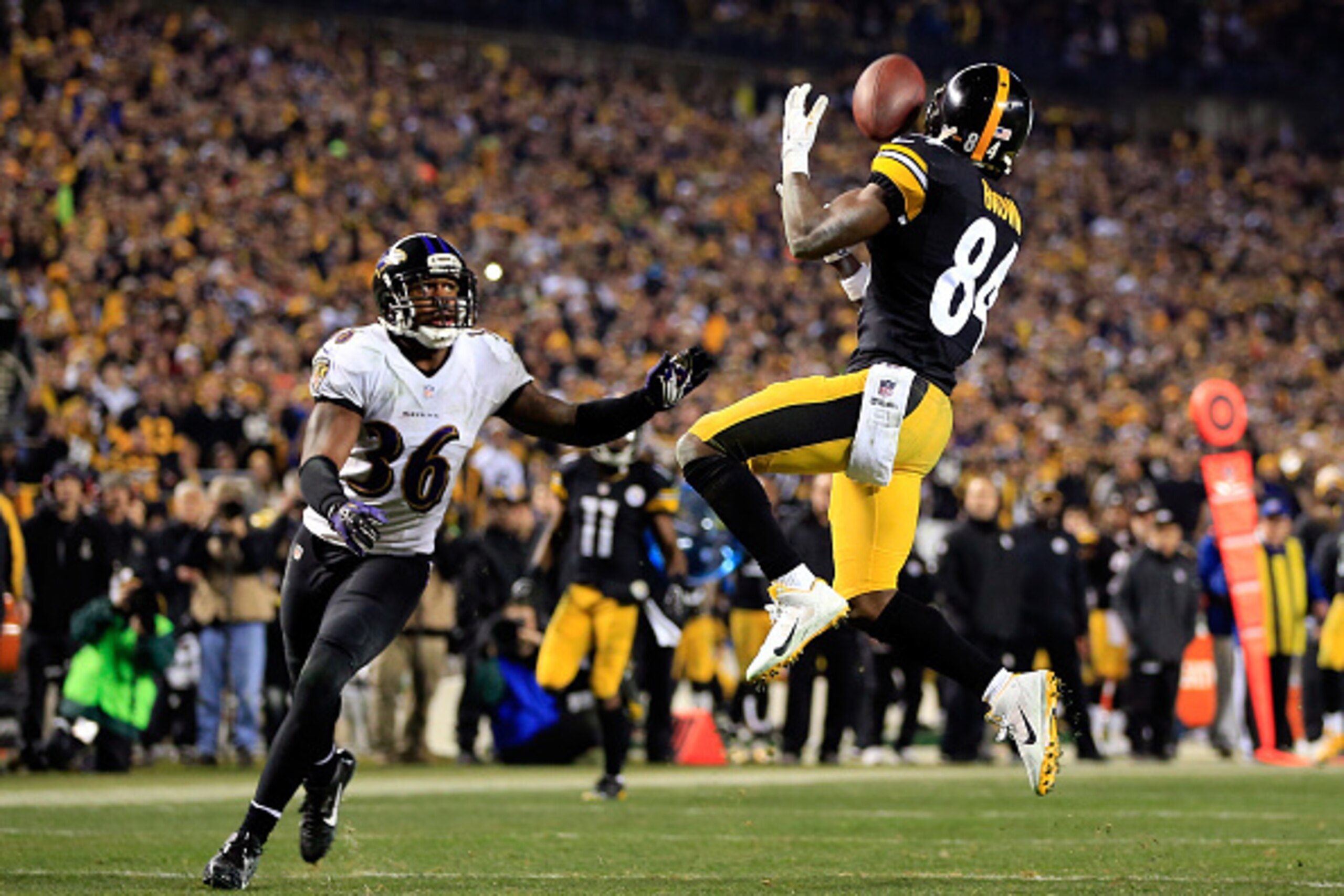 PITTSBURGH, PA - JANUARY 03:  Antonio Brown #84 of the Pittsburgh Steelers makes a catch as Jeromy Miles #36 of the Baltimore Ravens defends during their AFC Wild Card game at Heinz Field on January 3, 2015 in Pittsburgh, Pennsylvania.  (Photo by Jamie Sq