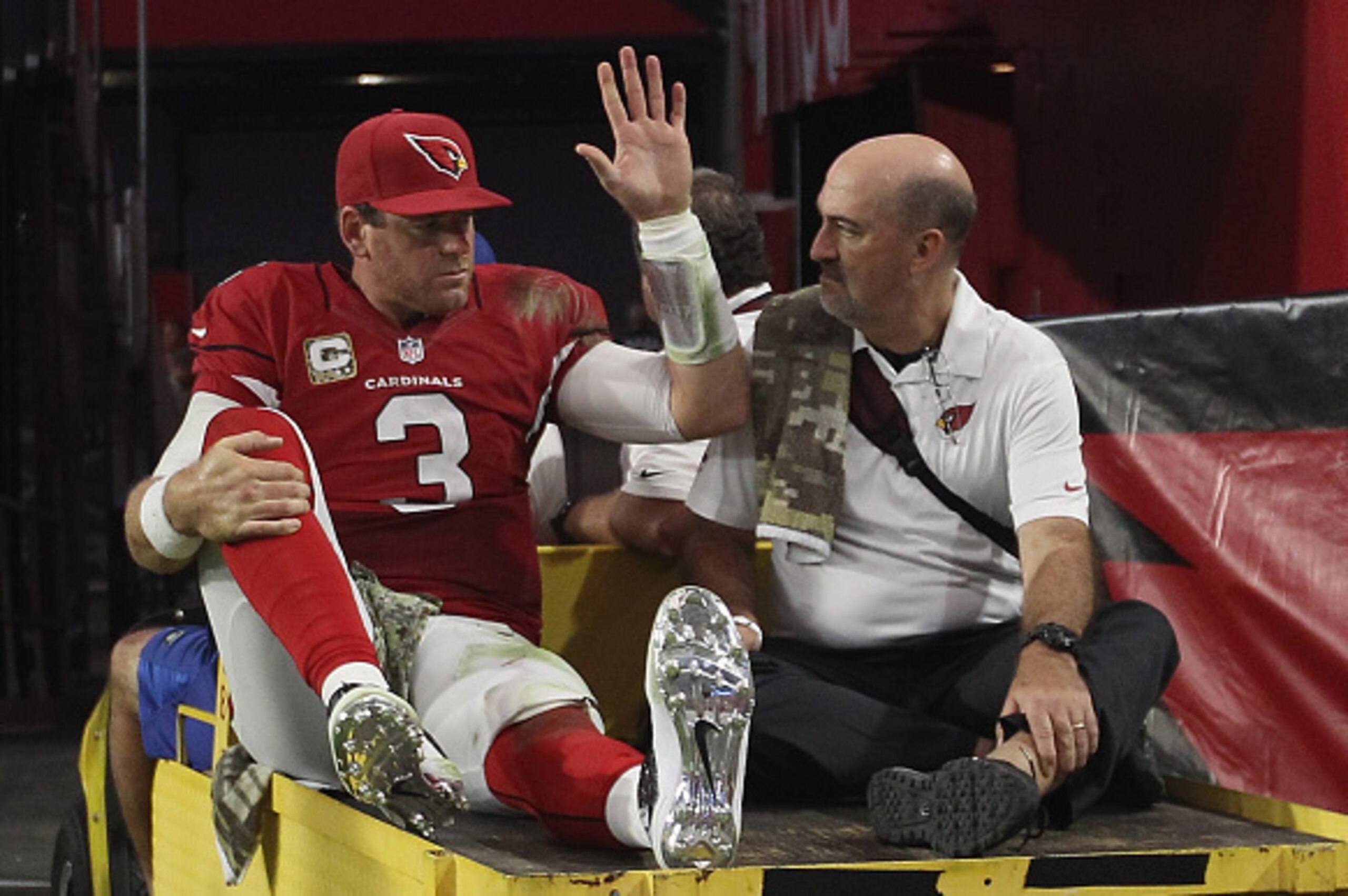 GLENDALE, AZ - NOVEMBER 09: Quarterback Carson Palmer #3 of the Arizona Cardinals waves while being carted off the field in the fourth quarter of the NFL game against the St. Louis Rams at University of Phoenix Stadium on November 9, 2014 in Glendale, Ar GLENDALE, AZ - NOVEMBER 09: Quarterback Carson Palmer #3 of the Arizona Cardinals waves while being carted off the field in the fourth quarter of the NFL game against the St. Louis Rams at University of Phoenix Stadium on November 9, 2014 in Glendale, Ar