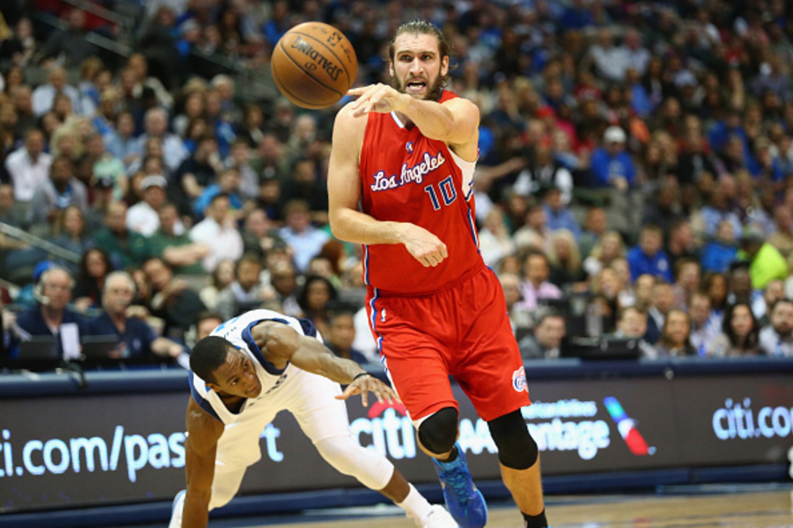 DALLAS, TX - MARCH 13:  Spencer Hawes #10 of the Los Angeles Clippers dribbles the ball against Rajon Rondo #9 of the Dallas Mavericks at American Airlines Center on March 13, 2015 in Dallas, Texas.   NOTE TO USER: User expressly acknowledges and agrees t