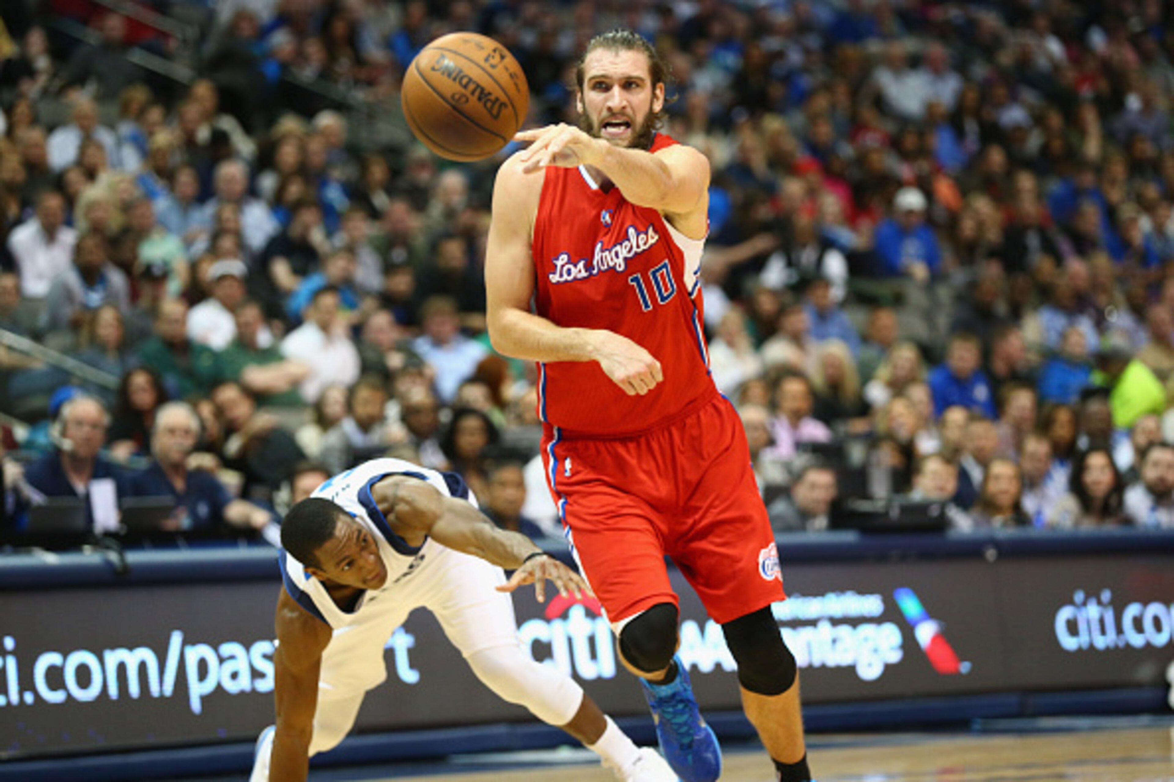 DALLAS, TX - MARCH 13:  Spencer Hawes #10 of the Los Angeles Clippers dribbles the ball against Rajon Rondo #9 of the Dallas Mavericks at American Airlines Center on March 13, 2015 in Dallas, Texas.   NOTE TO USER: User expressly acknowledges and agrees t