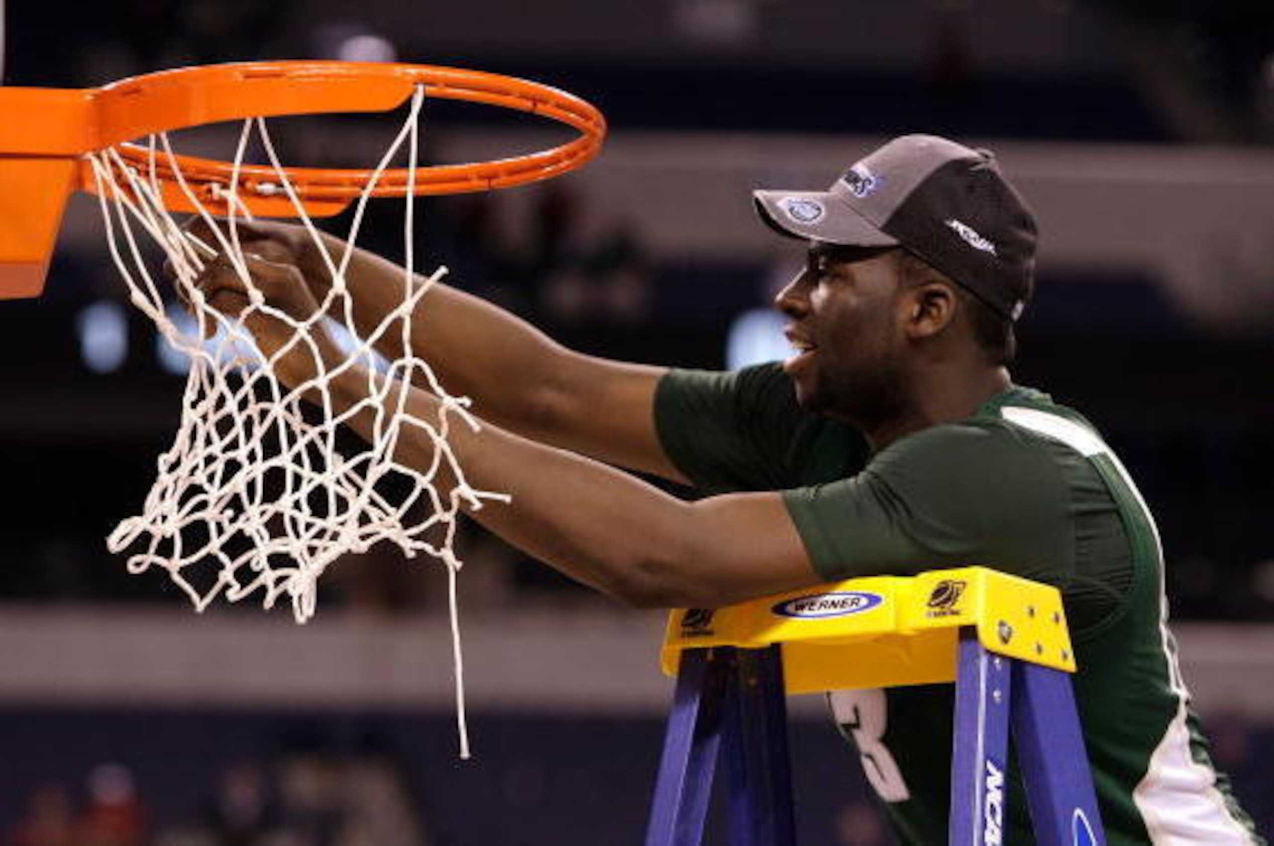 INDIANAPOLIS - MARCH 29:  Draymond Green #23 of the Michigan State Spartans cuts down a piece of the net following their 64-52 win against the Louisville Cardinals  during the fourth round of the NCAA Division I Men's Basketball Tournament at the Lucas Oi
