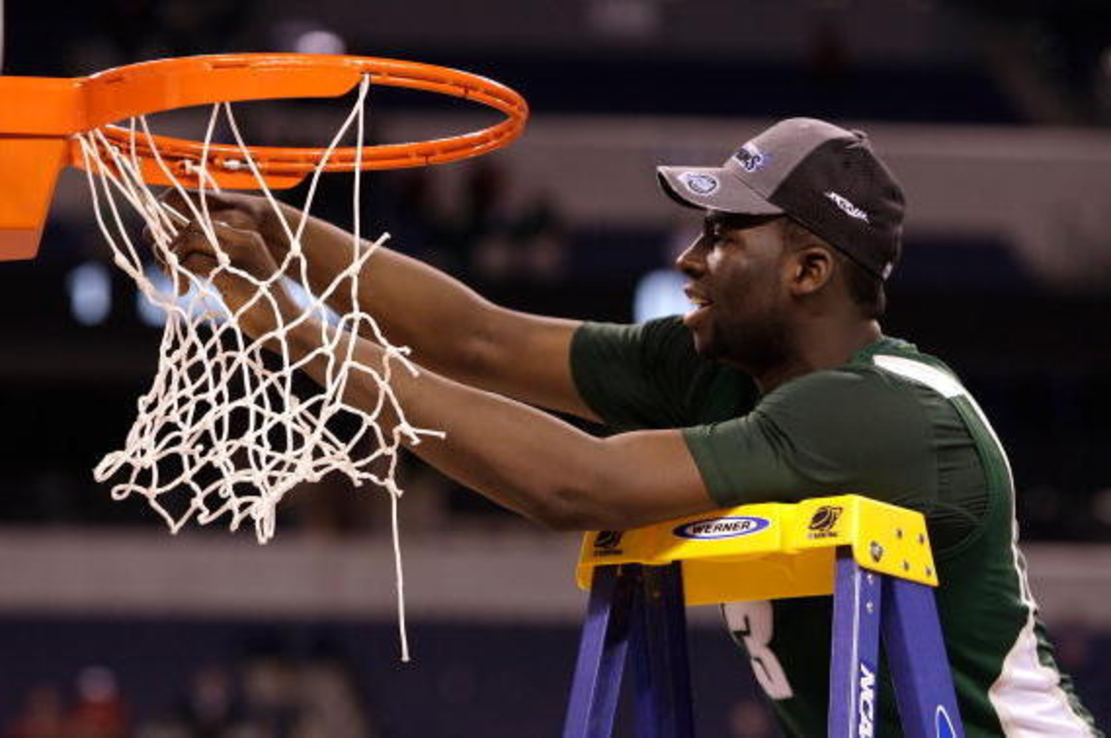 INDIANAPOLIS - MARCH 29:  Draymond Green #23 of the Michigan State Spartans cuts down a piece of the net following their 64-52 win against the Louisville Cardinals  during the fourth round of the NCAA Division I Men's Basketball Tournament at the Lucas Oi