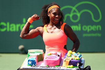 KEY BISCAYNE, FL - APRIL 01:  Serena Williams of the United States poses for a photograph with a cake to celebrate her 700th WTA Tour win after her three set victory against Sabine Lisicki of Germany in their quarter final match during the Miami Open Pres