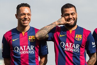 BARCELONA, SPAIN - FEBRUARY 18:  Dani Alves (C) of FC Barcelona jokes as he poses next to his teammates Adriano Correia (L) and Neymar during the presentation of a partnership agreement with Telefonica at Ciudad Deportiva de Sant Joan Despi on February 18