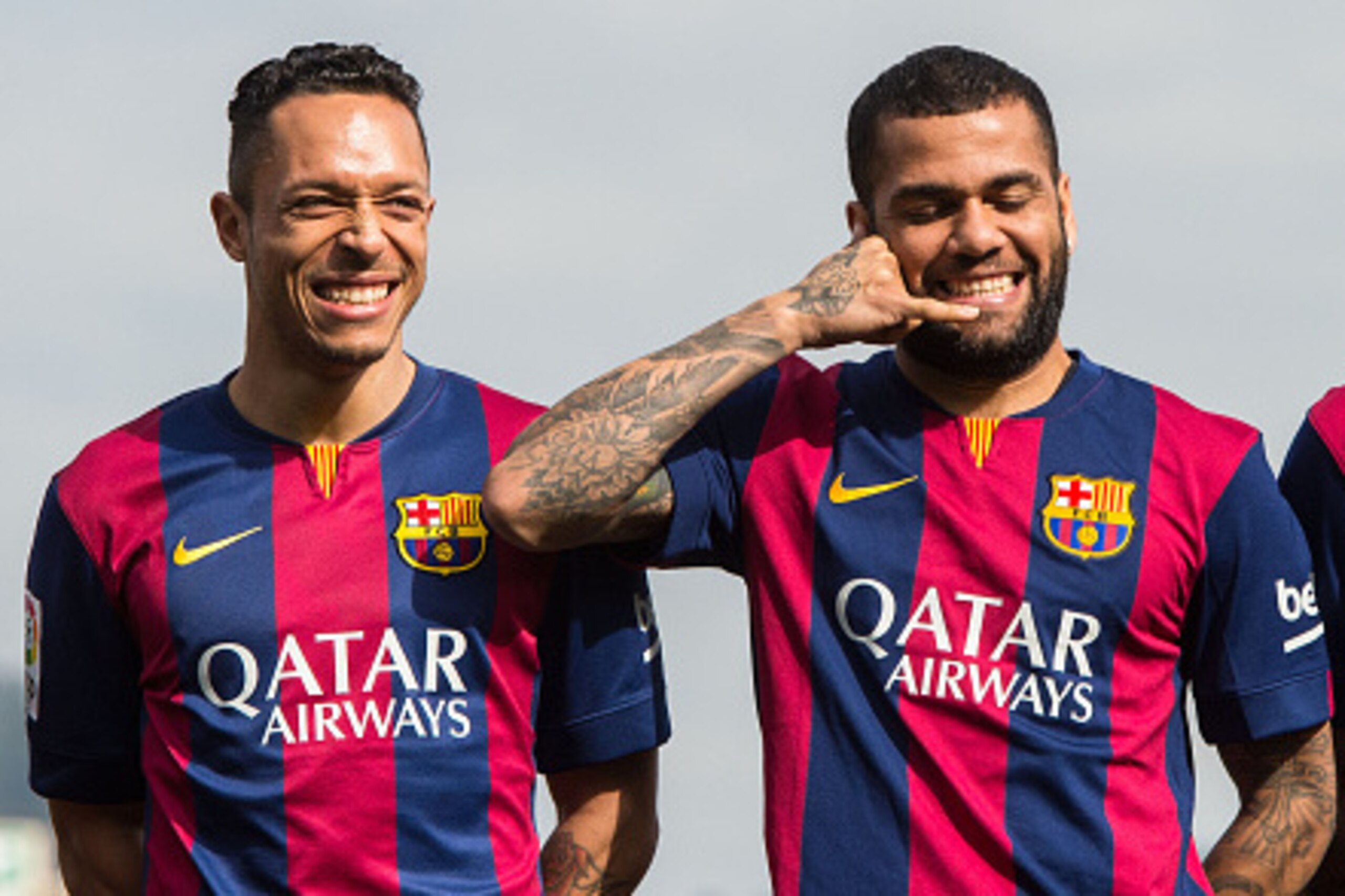 BARCELONA, SPAIN - FEBRUARY 18: Dani Alves (C) of FC Barcelona jokes as he poses next to his teammates Adriano Correia (L) and Neymar during the presentation of a partnership agreement with Telefonica at Ciudad Deportiva de Sant Joan Despi on February 18 BARCELONA, SPAIN - FEBRUARY 18: Dani Alves (C) of FC Barcelona jokes as he poses next to his teammates Adriano Correia (L) and Neymar during the presentation of a partnership agreement with Telefonica at Ciudad Deportiva de Sant Joan Despi on February 18