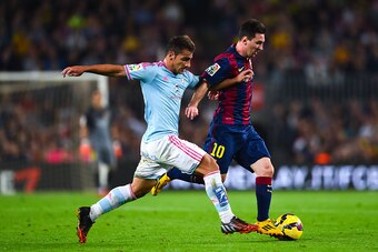BARCELONA, SPAIN - NOVEMBER 01:  Lionel Messi of FC Barcelona duels for the ball with Jonny of Celta de Vigo during the La Liga match between FC Barcelona and Celta de Vigo at Camp Nou on November 1, 2014 in Barcelona, Spain.  (Photo by David Ramos/Getty 