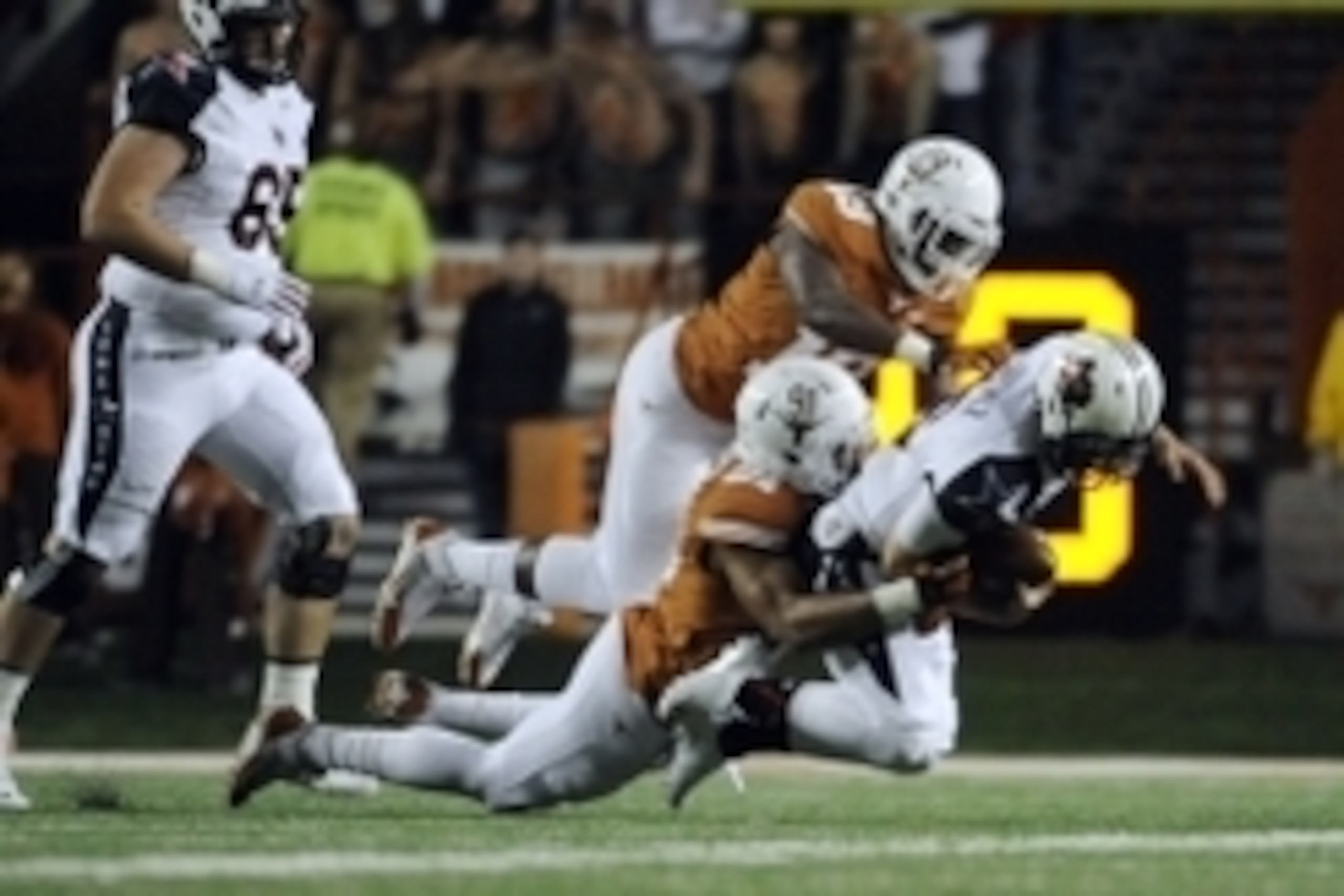 Nov 28, 2013; Austin, TX, USA; Texas Longhorns defensive end Bryce Cottrell (91) and linebacker Peter Jinkens (19) tackle Texas Tech Red Raiders quarterback Michael Brewer (16) during the second half at Darrell K Royal-Texas Memorial Stadium. Texas beat T