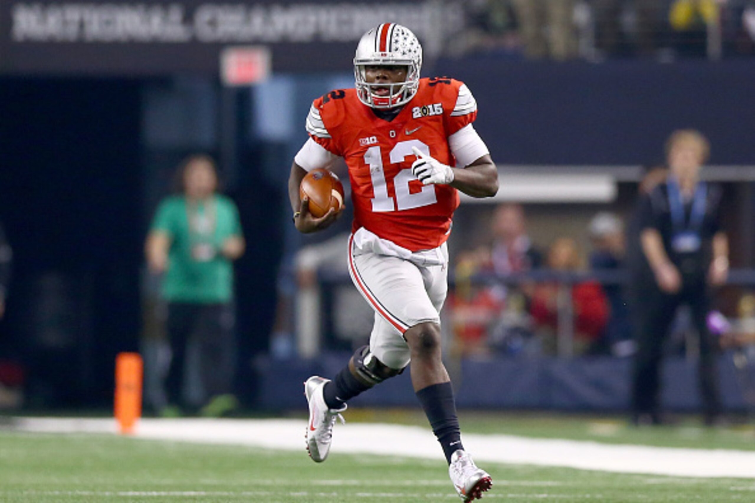ARLINGTON, TX - JANUARY 12:  Quarterback Cardale Jones #12 of the Ohio State Buckeyes runs the ball against the Oregon Ducks during the College Football Playoff National Championship Game at AT&T Stadium on January 12, 2015 in Arlington, Texas.  (Photo by