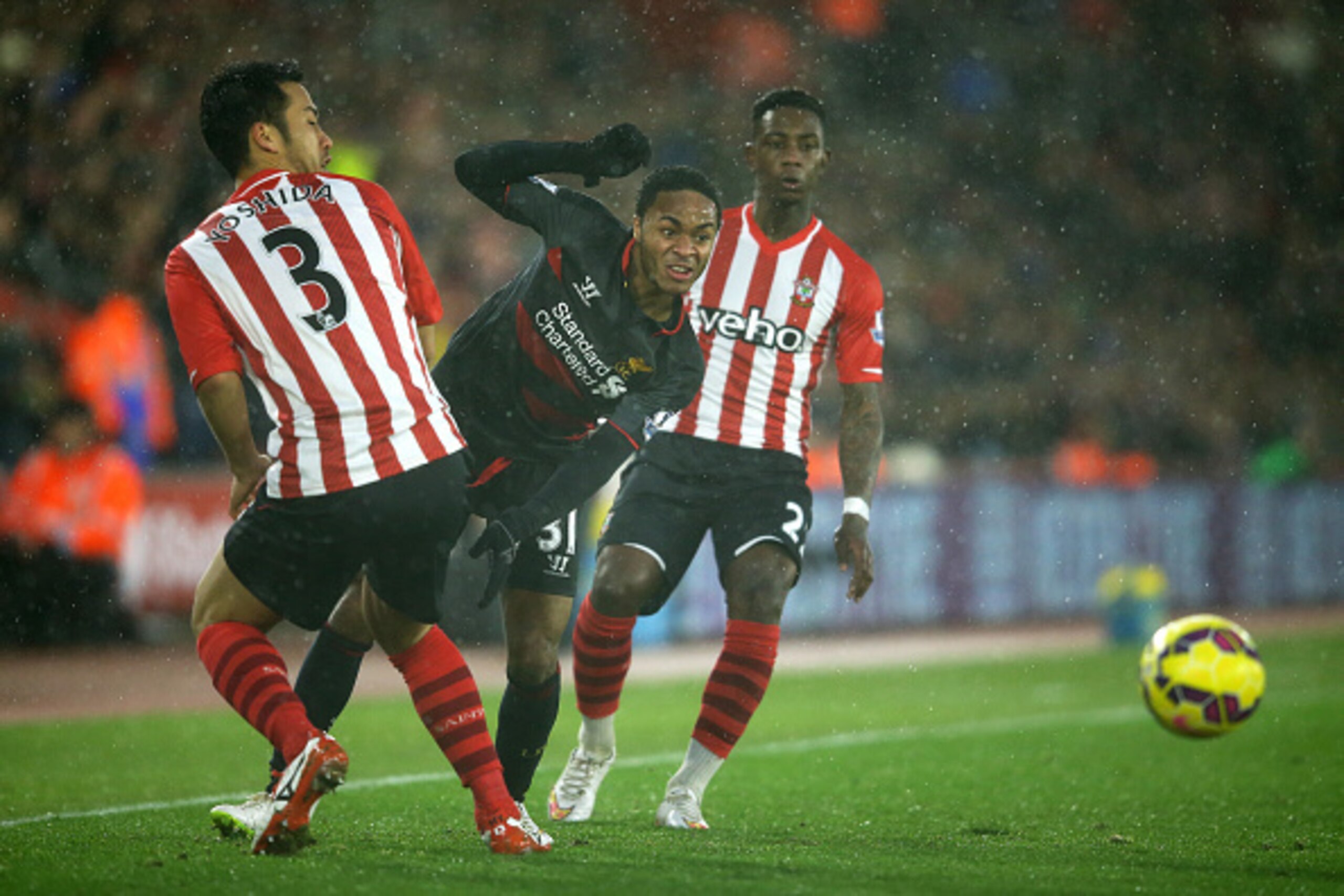 SOUTHAMPTON, ENGLAND - FEBRUARY 22:  Raheem Sterling of Liverpool is tackled by Maya Yoshida of Southampton during the Barclays Premier League match between Southampton and Liverpool at St Mary's Stadium on February 22, 2015 in Southampton, England.  (Pho