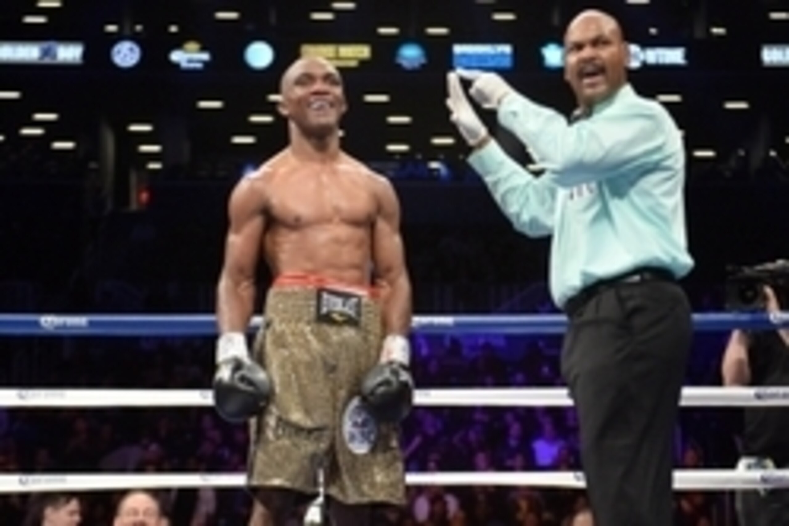 Dec 7, 2013; Brooklyn, NY, USA; Sakio Bika (gold trunks) is knocked down by Anthony Dirrell (green trunks) during their WBC Super Middleweight Title bout at Barclays Center. The bout ended in a split draw. Mandatory Credit: Joe Camporeale-USA TODAY Sports