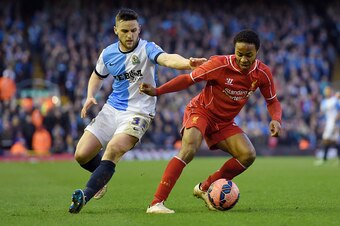 LIVERPOOL, ENGLAND - MARCH 08:  Raheem Sterling of Liverpool is challenged by Craig Conway of Blackburn during the FA Cup Quarter Final match between Liverpool and Blackburn Rovers at Anfield on March 8, 2015 in Liverpool, England.  (Photo by Michael Rega
