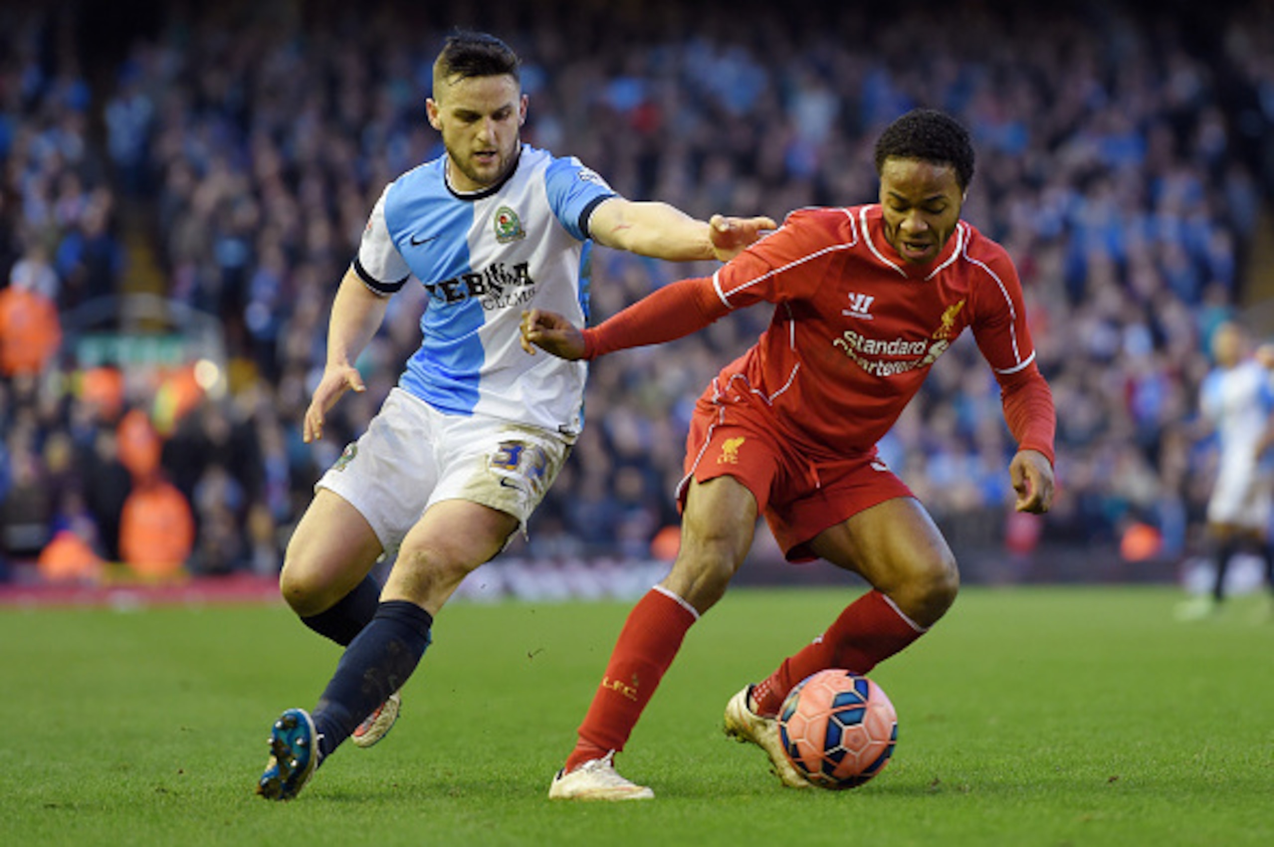 LIVERPOOL, ENGLAND - MARCH 08:  Raheem Sterling of Liverpool is challenged by Craig Conway of Blackburn during the FA Cup Quarter Final match between Liverpool and Blackburn Rovers at Anfield on March 8, 2015 in Liverpool, England.  (Photo by Michael Rega
