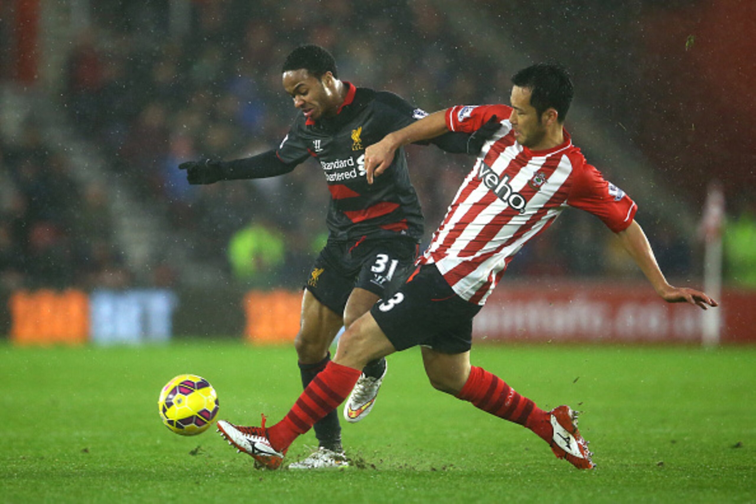 SOUTHAMPTON, ENGLAND - FEBRUARY 22:  Raheem Sterling of Liverpool is tackled by Maya Yoshida of Southampton during the Barclays Premier League match between Southampton and Liverpool at St Mary's Stadium on February 22, 2015 in Southampton, England.  (Pho