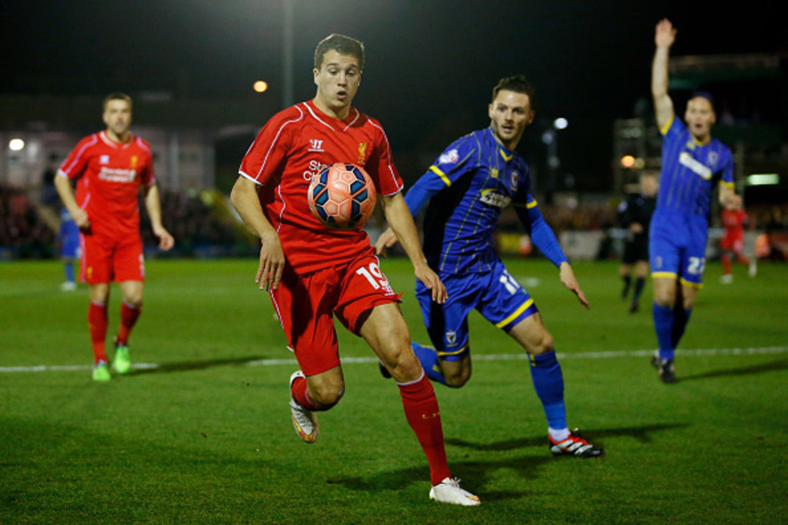KINGSTON UPON THAMES, ENGLAND - JANUARY 05:  Javi Manquillo of Liverpool controls the ball as Callum Kennedy of AFC Wimbledon closes in during the FA Cup Third Round match between AFC Wimbledon and Liverpool at The Cherry Red Records Stadium on January 5,