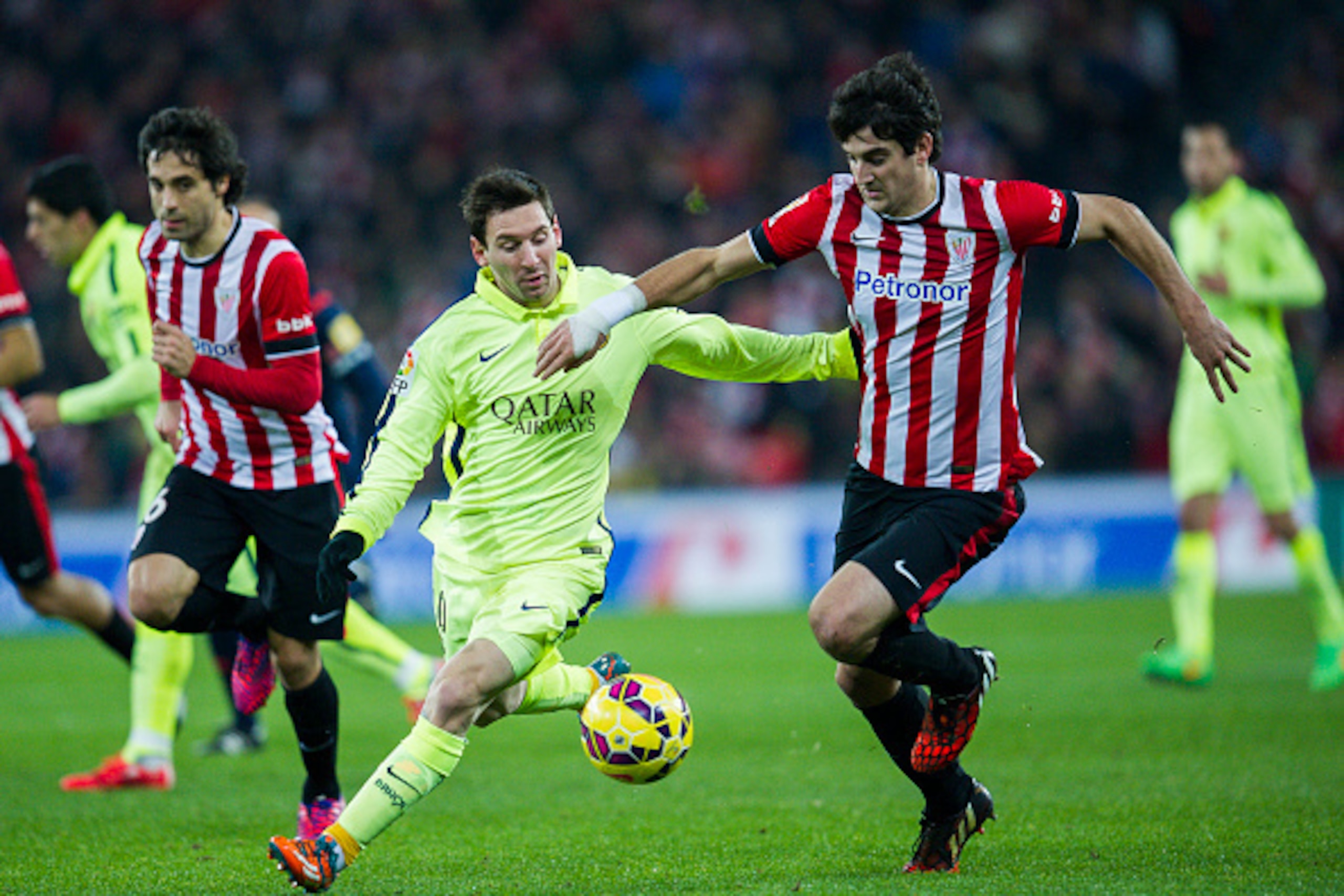 BILBAO, SPAIN - FEBRUARY 08:  Lionel Messi of FC Barcelona duels for the ball with Mikel San Jose of Athletic Club during the La Liga match between Athletic Club and FC Barcelona at San Mames Stadium on February 8, 2015 in Bilbao, Spain.  (Photo by Juan M