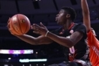 Apr 2, 2014; Chicago, IL, USA; McDonald's All American West guard Emmanuel Mudiay (0) shoots the ball against McDonald's All American East center Myles Turner (35) during the second half at the United Center. The West defeats the East 105-102. Mandatory C
