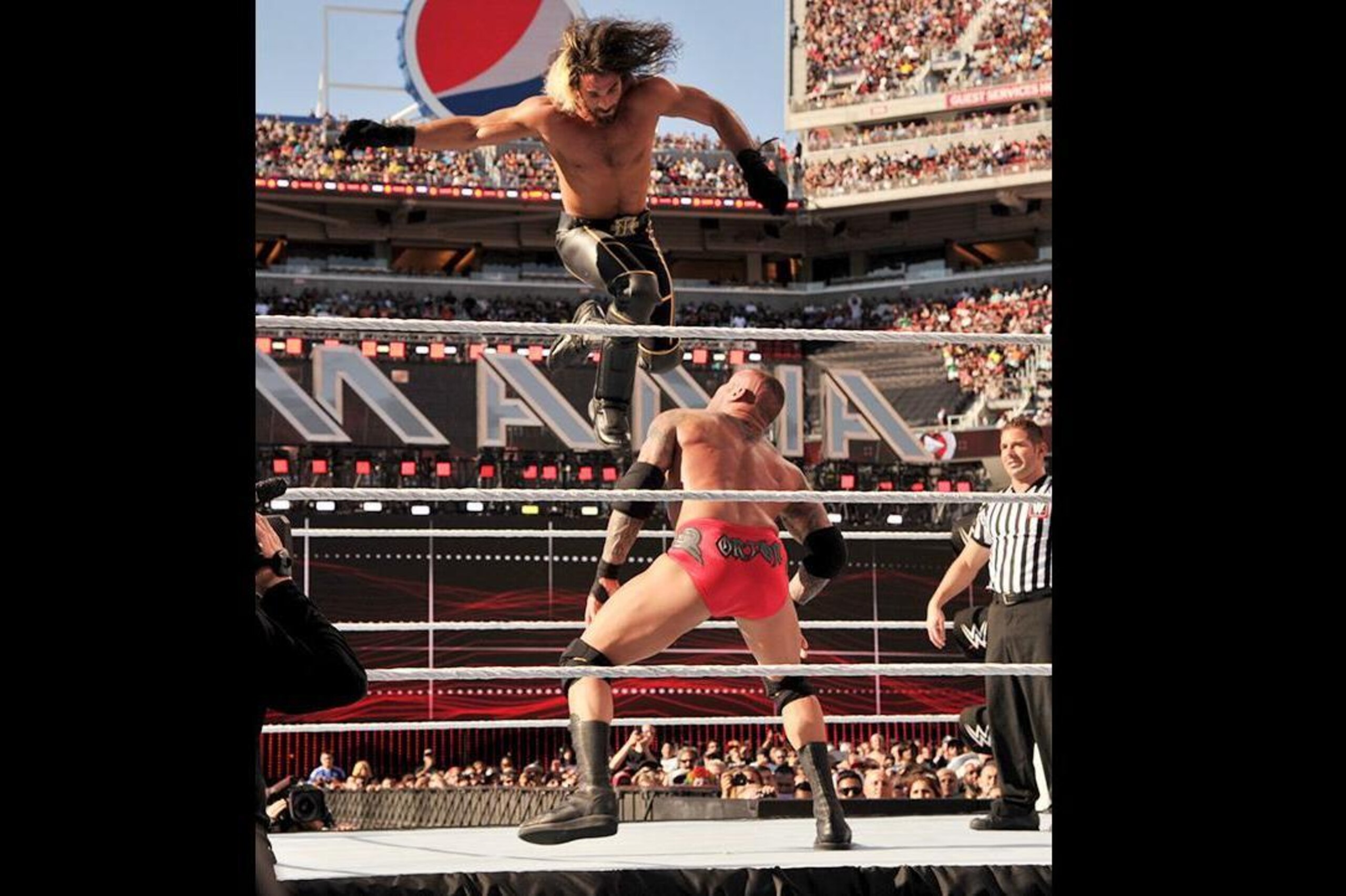 Randy Orton prepares to hit Seth Rollins with an RKO.