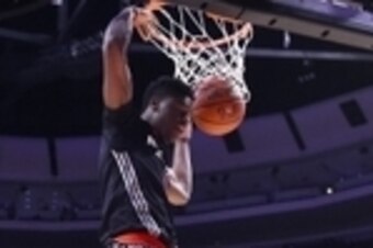 Apr 2, 2014; Chicago, IL, USA; McDonald's All American West guard Emmanuel Mudiay (0) dunks the ball against the East during the second half at the United Center. The West defeats the East 105-102. Mandatory Credit: Mike DiNovo-USA TODAY Sports