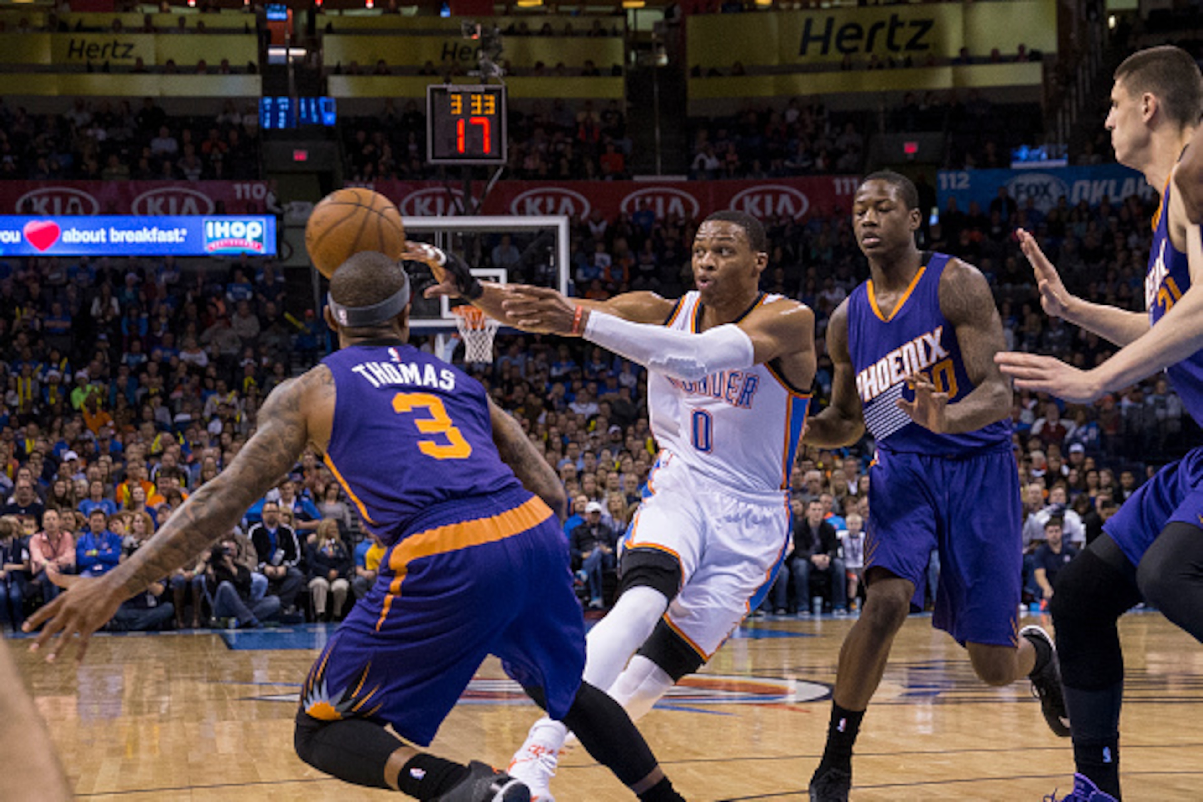 OKLAHOMA CITY, OK - DECEMBER 14: Russell Westbrook #0 of the Oklahoma City Thunder passes the ball against the Phoenix Suns at the Chesapeake Energy Arena  on December 14, 2013 in Oklahoma City, Oklahoma. NOTE TO USER:  User expressly acknowledges and agr