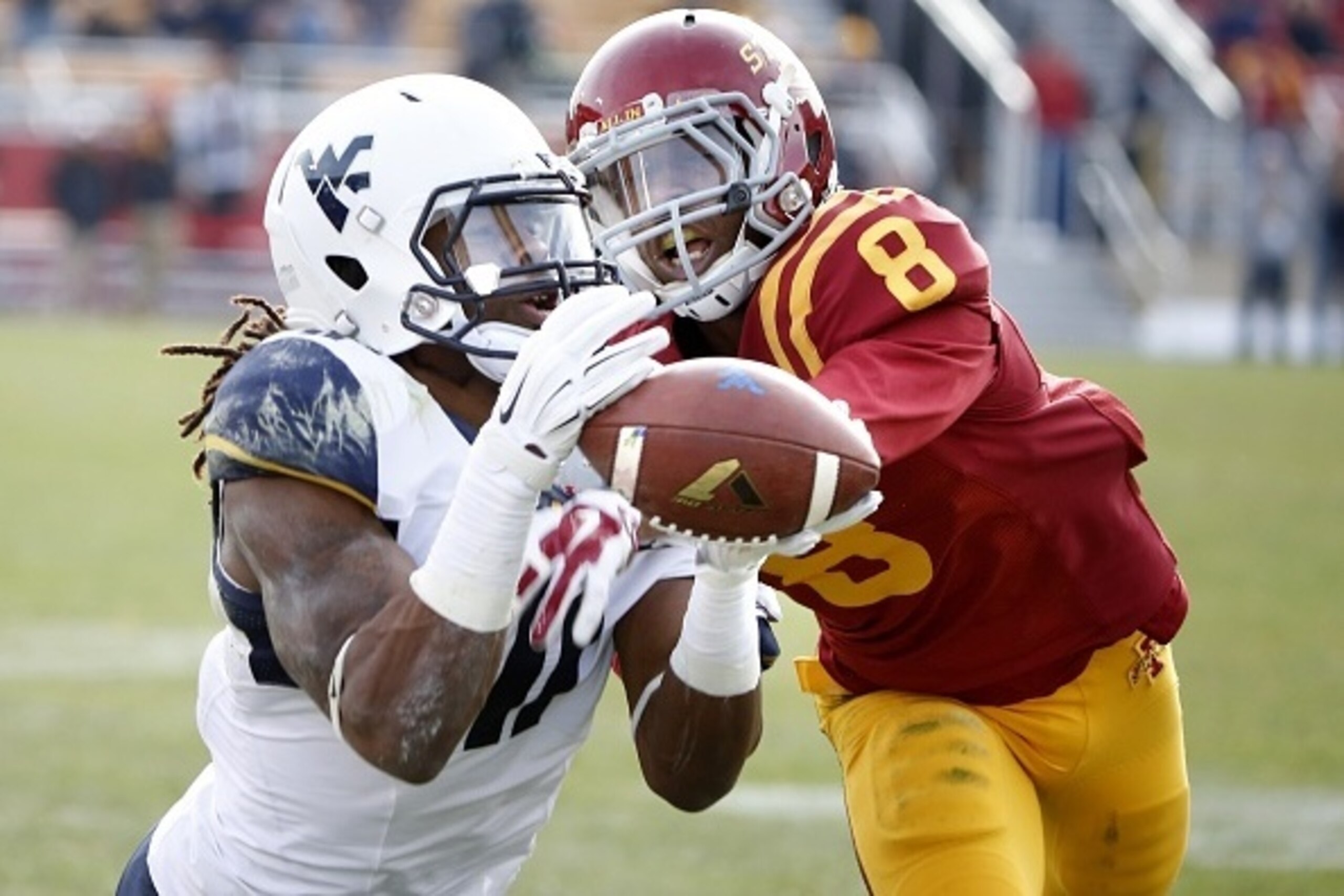 AMES, IA - NOVEMBER 29: Defensive back Kenneth Lynn #8 of the Iowa State Cyclones breaks up a pass meant for wide receiver Kevin White #11 of the West Virginia Mountaineers in the second half of play at Jack Trice Stadium on November 29, 2014 in Ames, Iow
