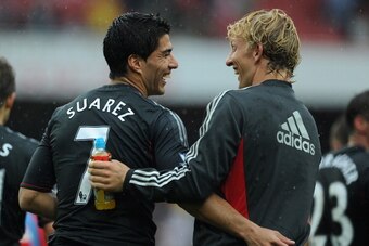LONDON, ENGLAND - AUGUST 20:  Luis Suarez and Dirk Kuyt of Liverpool share a joke as they celebrate victory after the Barclays Premier League match between Arsenal and Liverpool at the Emirates Stadium on August 20, 2011 in London, England.  (Photo by Mic