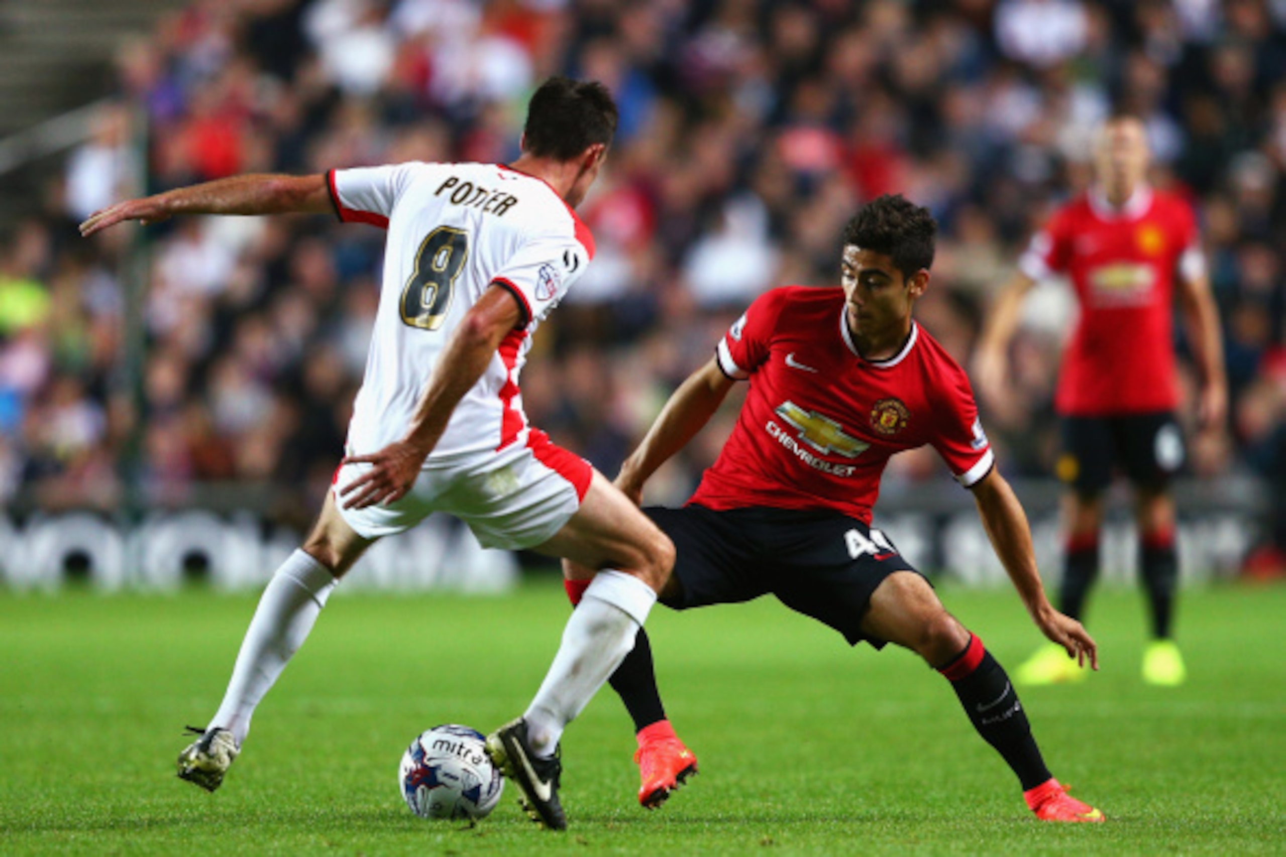 MILTON KEYNES, ENGLAND - AUGUST 26: Andreas Pereira of Manchester United takes on Darren Potter of Milton Keynes Dons during the Capital One Cup Second Round match between MK Dons and Manchester United at Stadium mk on August 26, 2014 in Milton Keynes, En