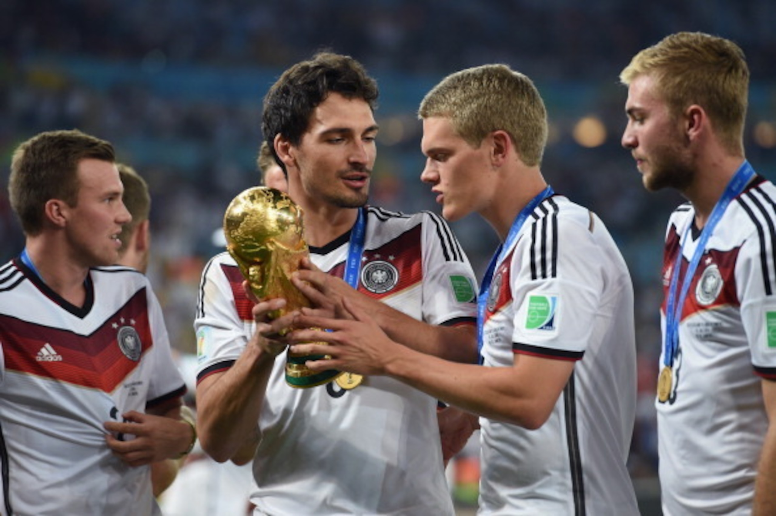 RIO DE JANEIRO, BRAZIL - JULY 13:  Mats Hummels and Matthias Ginter celebrate with the World Cup trophy  after defeating Argentina 1-0 in extra time during the 2014 FIFA World Cup Brazil Final match between Germany and Argentina at Maracana on July 13, 20