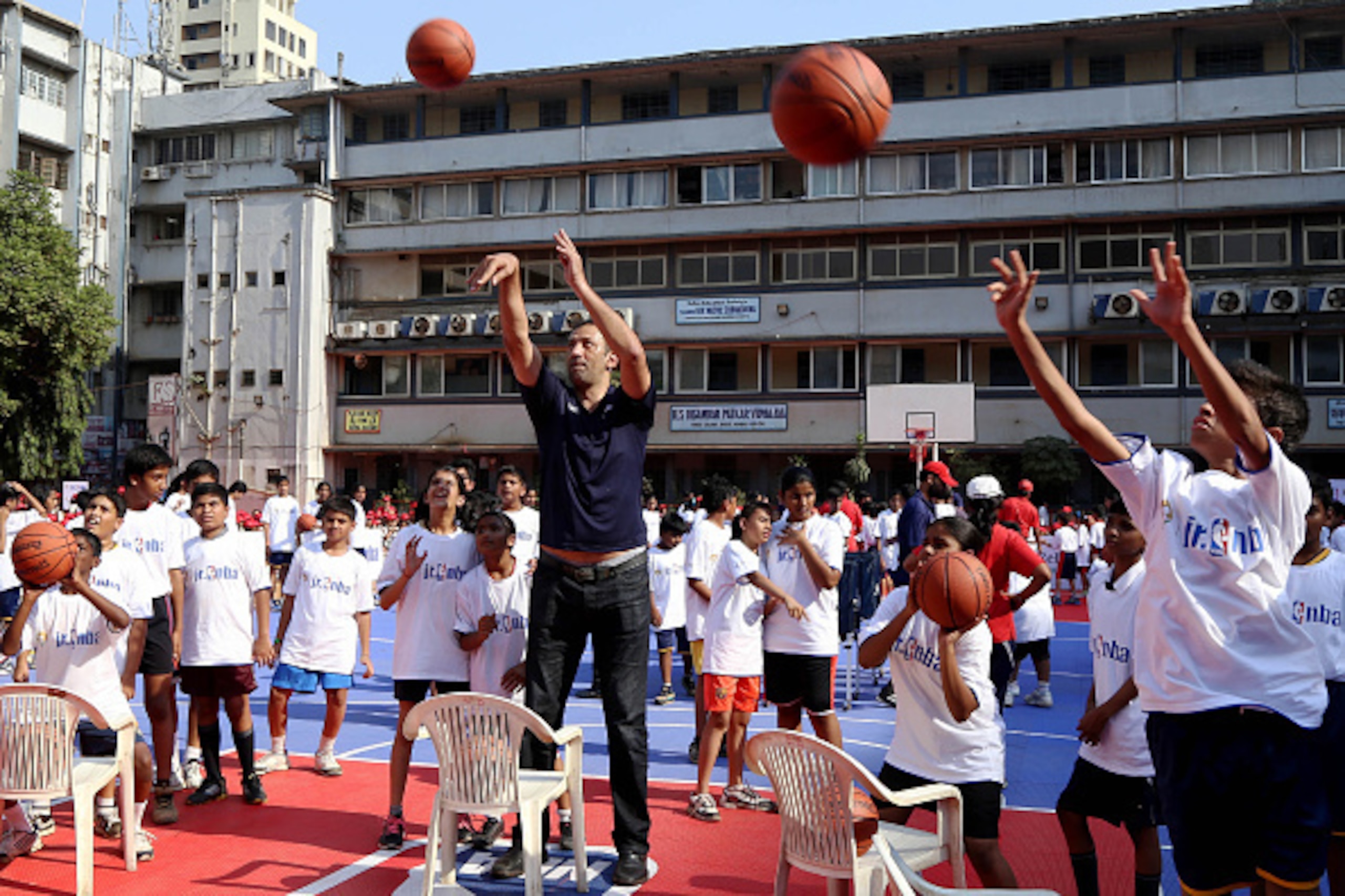 MUMBAI, INDIA  - DECEMBER 2:  Vlade Divac coaches during a clinic at the Reliance Foundation Jr. NBA Youth Program at I.E.S. V.N. Sule Guruji School in Mumbai, India on December 2, 2014.  NOTE TO USER: User expressly acknowledges and agrees that, by downl