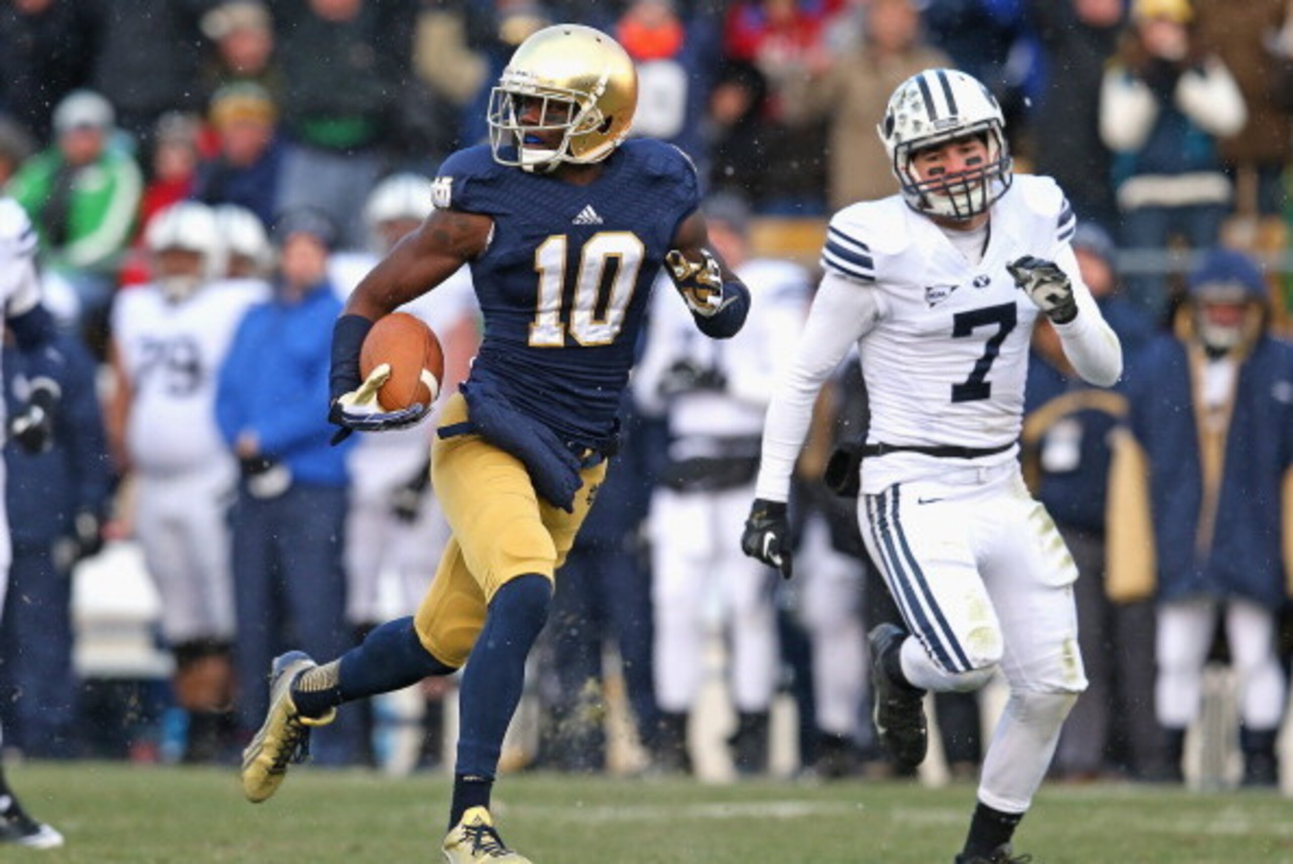 SOUTH BEND, IN - NOVEMBER 23:  DaVaris Daniels #10 of the Notre Dame Fighting Irish runs for a touchdown after a catch in front of Skye PoVey #7 of the Brigham Young Cougars at Notre Dame Stadium on November 23, 2013 in South Bend, Indiana. Notre Dame def