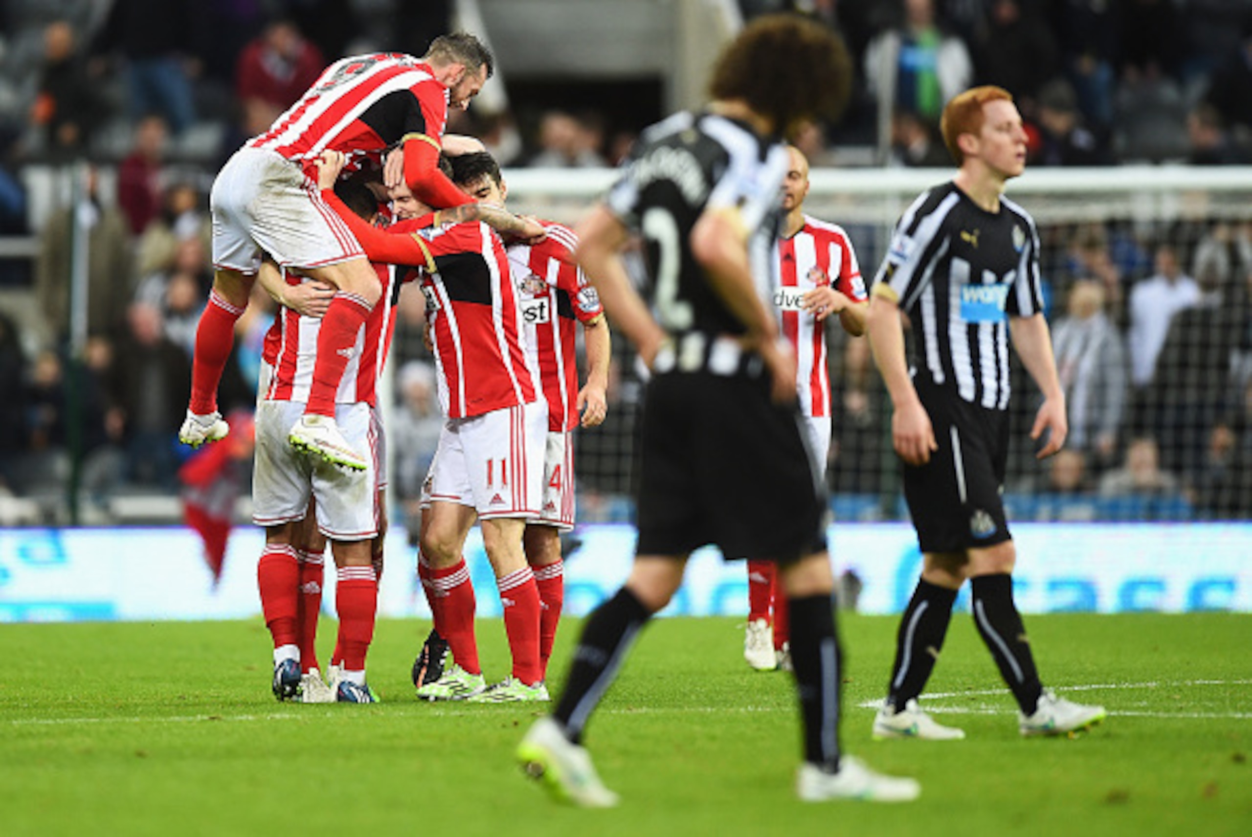 NEWCASTLE UPON TYNE, ENGLAND - DECEMBER 21:  Sunderland players mob Adam Johnson of Sunderland as they celebrate victory after the Barclays Premier League match between Newcastle United and Sunderland at St James' Park on December 21, 2014 in Newcastle up