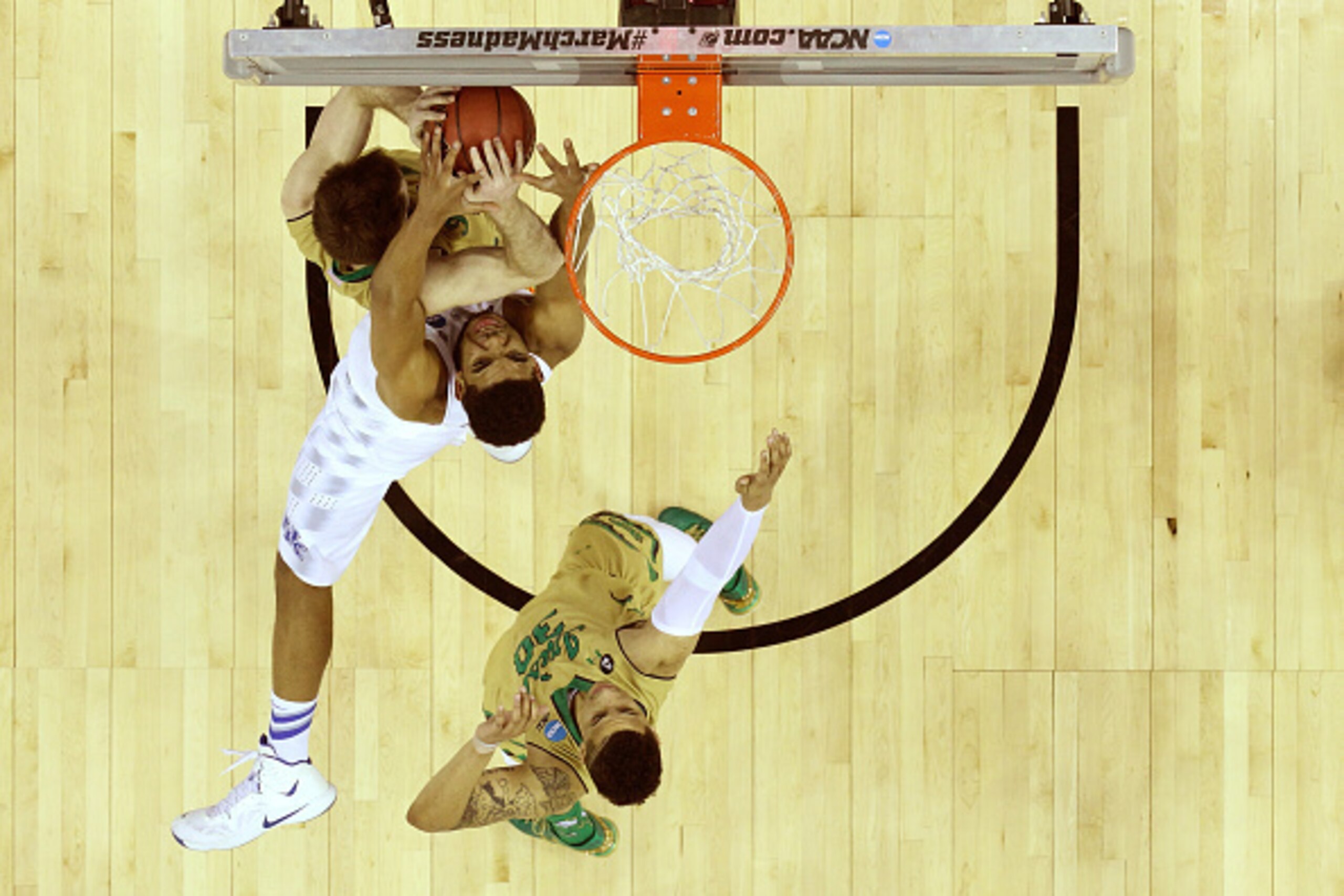 CLEVELAND, OH - MARCH 28: Karl-Anthony Towns #12 of the Kentucky Wildcats goes for a rebound against Pat Connaughton #24 and Zach Auguste #30 of the Notre Dame Fighting Irish during the Midwest Regional Final of the 2015 NCAA Men's Basketball tournament a