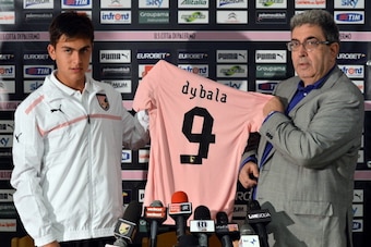 BOLZANO, ITALY - JULY 21:  Paulo Dybala poses with Sport Manager Giorgio Perinetti (R) showing his new shirt during his presentation as the club's new signing after a US Citta di Palermo pre-season training session at Sport Well Center on July 21, 2012 in