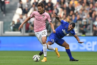 TURIN, ITALY - OCTOBER 26:  Carlos Tevez (R) of Juventus FC tackles Franco Vazquez of US Citta di Palermo during the Serie A match between Juventus FC and US Citta di Palermo at Juventus Arena on October 26, 2014 in Turin, Italy.  (Photo by Valerio Pennic