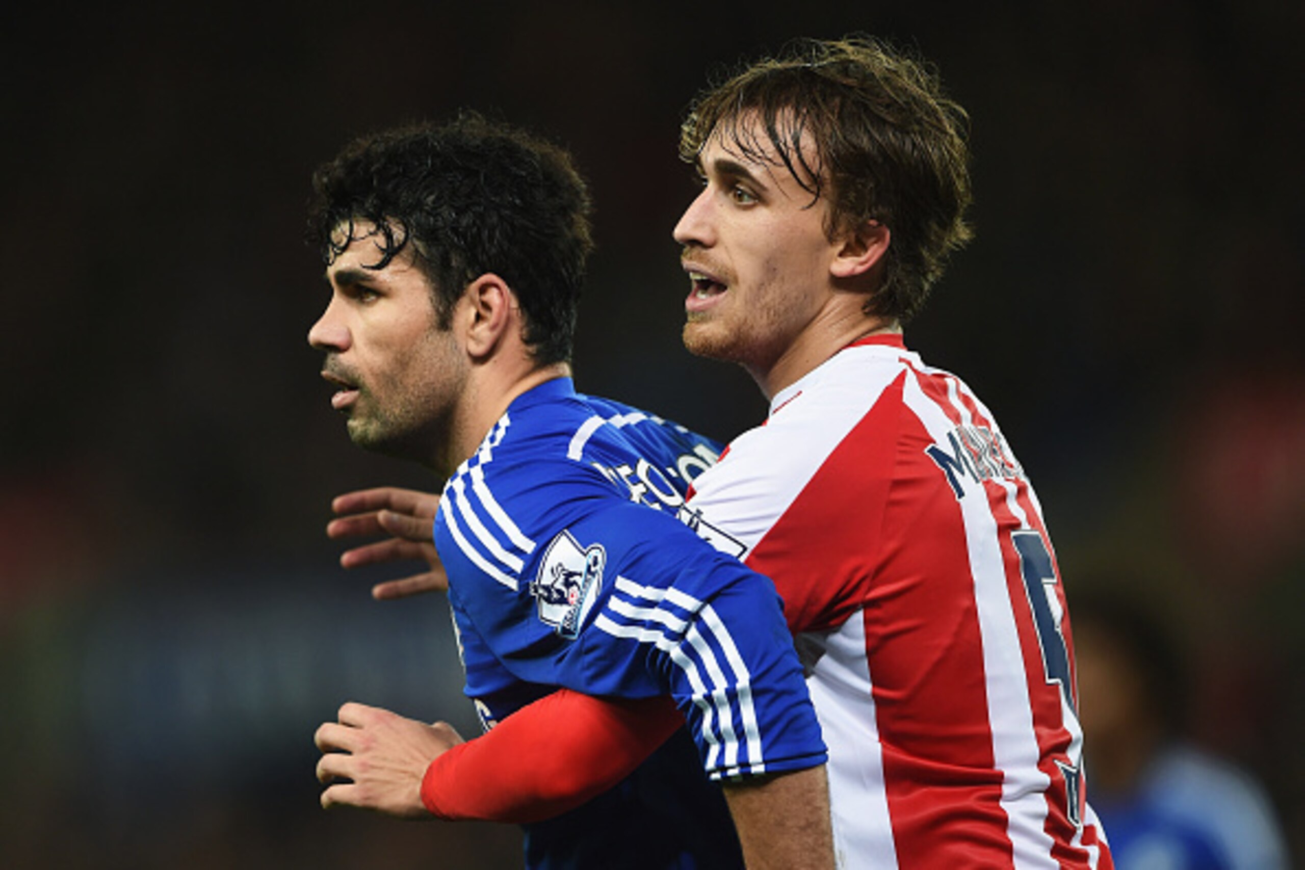 STOKE ON TRENT, ENGLAND - DECEMBER 22:  Diego Costa of Chelsea is held by Marc Muniesa of Stoke City during the Barclays Premier League match between Stoke City and Chelsea at Britannia Stadium on December 22, 2014 in Stoke on Trent, England.  (Photo by M