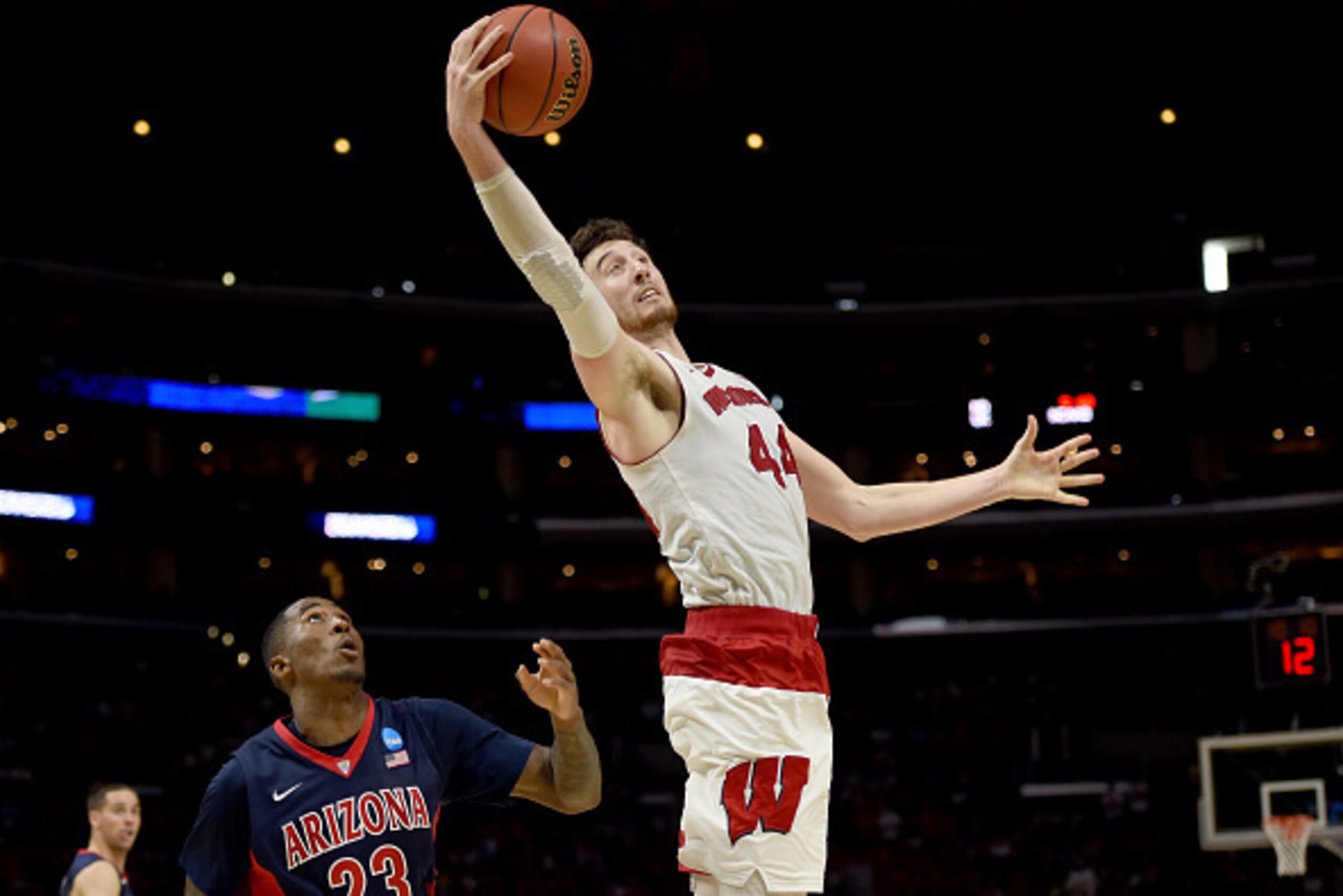 LOS ANGELES, CA - MARCH 28:  Frank Kaminsky #44 of the Wisconsin Badgers with the ball against Rondae Hollis-Jefferson #23 of the Arizona Wildcats in the second half during the West Regional Final of the 2015 NCAA Men's Basketball Tournament at Staples Ce