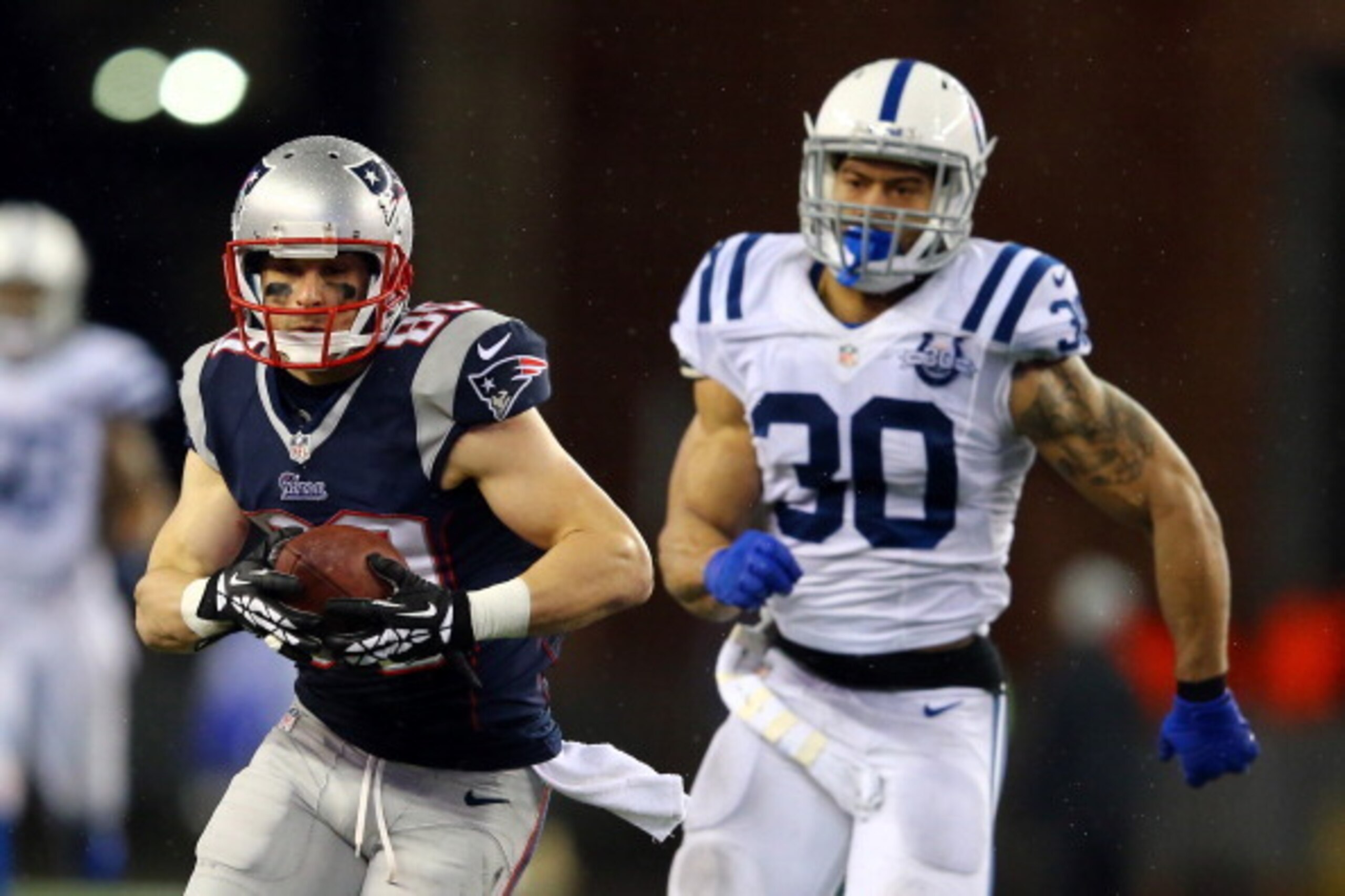 FOXBORO, MA - JANUARY 11:   Danny Amendola #80 of the New England Patriots runs the ball against  LaRon Landry #30 of the Indianapolis Colts  during the AFC Divisional Playoff game at Gillette Stadium on January 11, 2014 in Foxboro, Massachusetts.  (Photo
