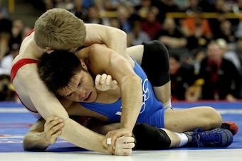 IOWA CITY, IA - APRIL 22:  Nick Simmons (red) wrestles Henry Cejudo (blue) in the 55 kg freestyle weight class during the challenge tournament for the finals of the US Wrestling Olympic Trials at Carver Hawkeye Arena on April 22, 2012 in Iowa City, Iowa. 