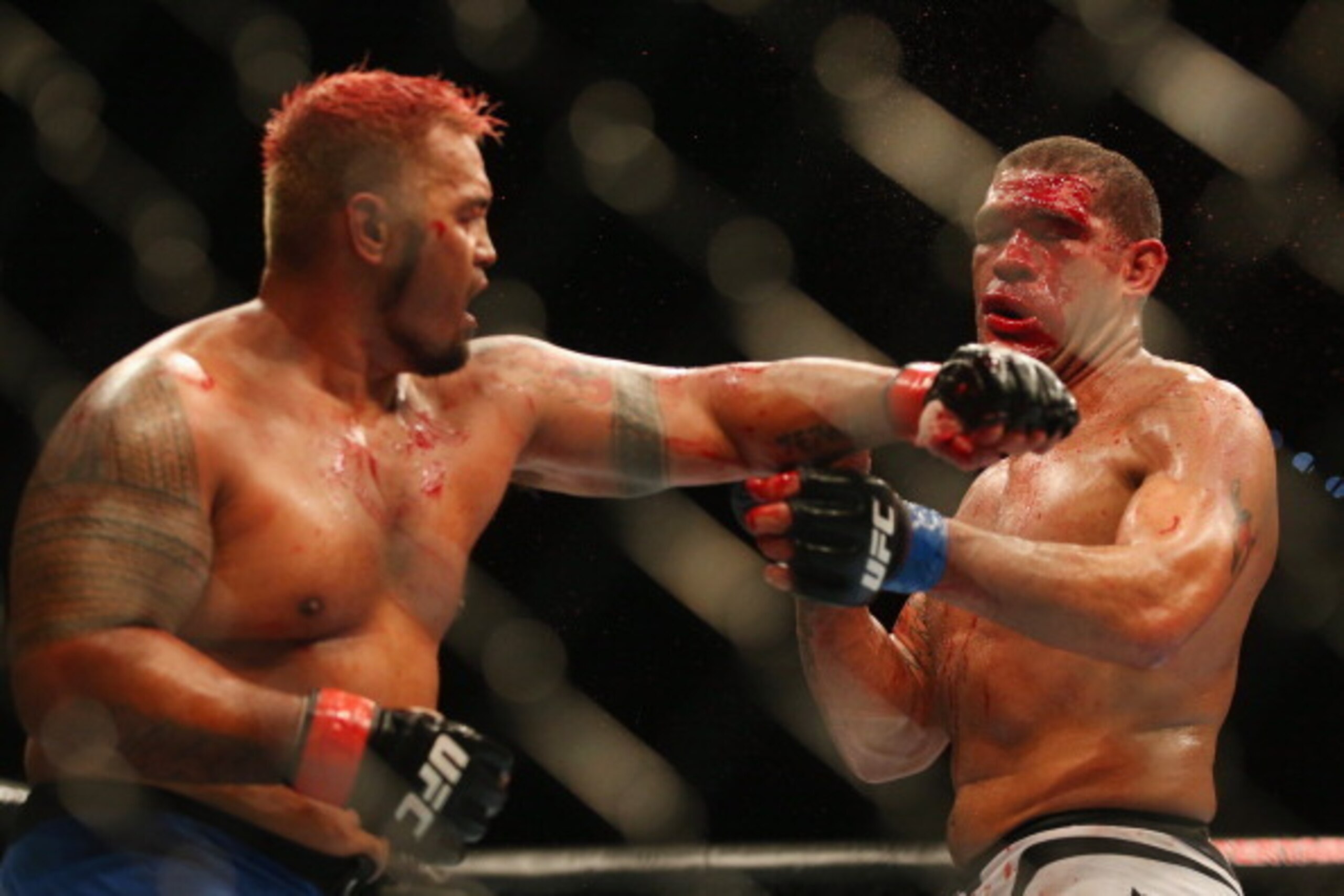 BRISBANE, AUSTRALIA - DECEMBER 07:  Mark Hunt punches Antonio 'Big Foot' Silva of Brazil during the UFC Brisbane bout between Mark Hunt and Antonio 'Big Foot' Silva of Brazil at Brisbane Entertainment Centre on December 7, 2013 in Brisbane, Australia.  (P