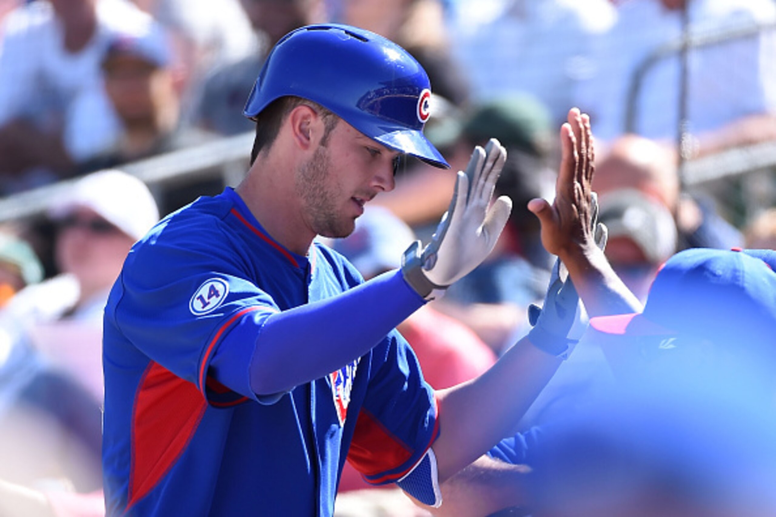 MESA, AZ - MARCH 24:  Kris Bryant #76 of the Chicago Cubs celebrates with teammates after hitting a third-inning home run against the Oakland Athletics in a preseason Cactus League game at HoHokam Stadium on March 24, 2015 in Mesa, Arizona.  (Photo by Nor