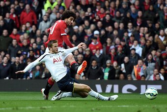 MANCHESTER, ENGLAND - MARCH 15:  Marouane Fellaini of Manchester United shoots past Eric Dier of Spurs to score the opening goal during the Barclays Premier League match between Manchester United and Tottenham Hotspur at Old Trafford on March 15, 2015 in 